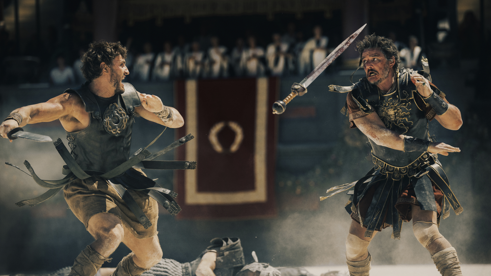 Still from Gladiator II showing Paul Mescal and Pedro Pascal as gladiators fighting in Coliseum