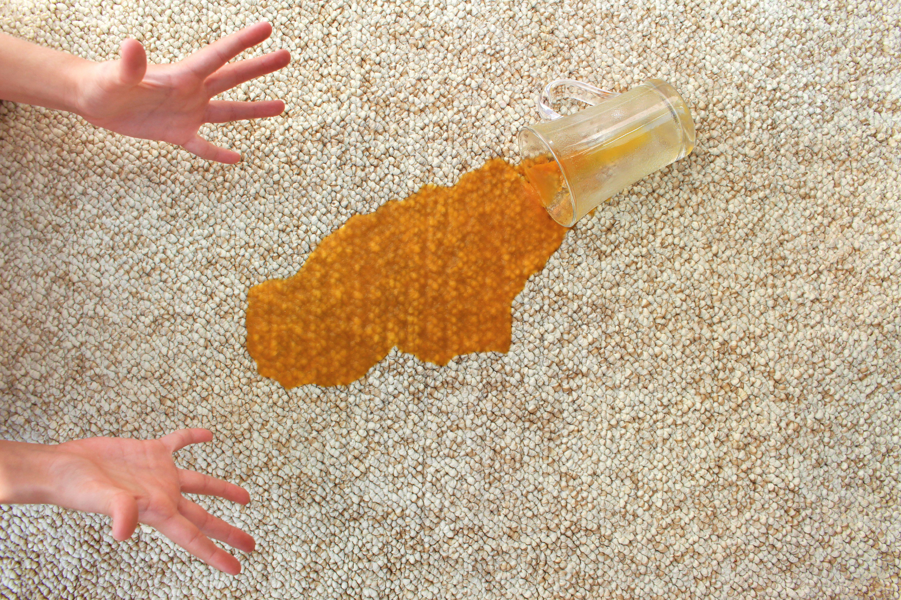 Spilled glass of juice on carpet