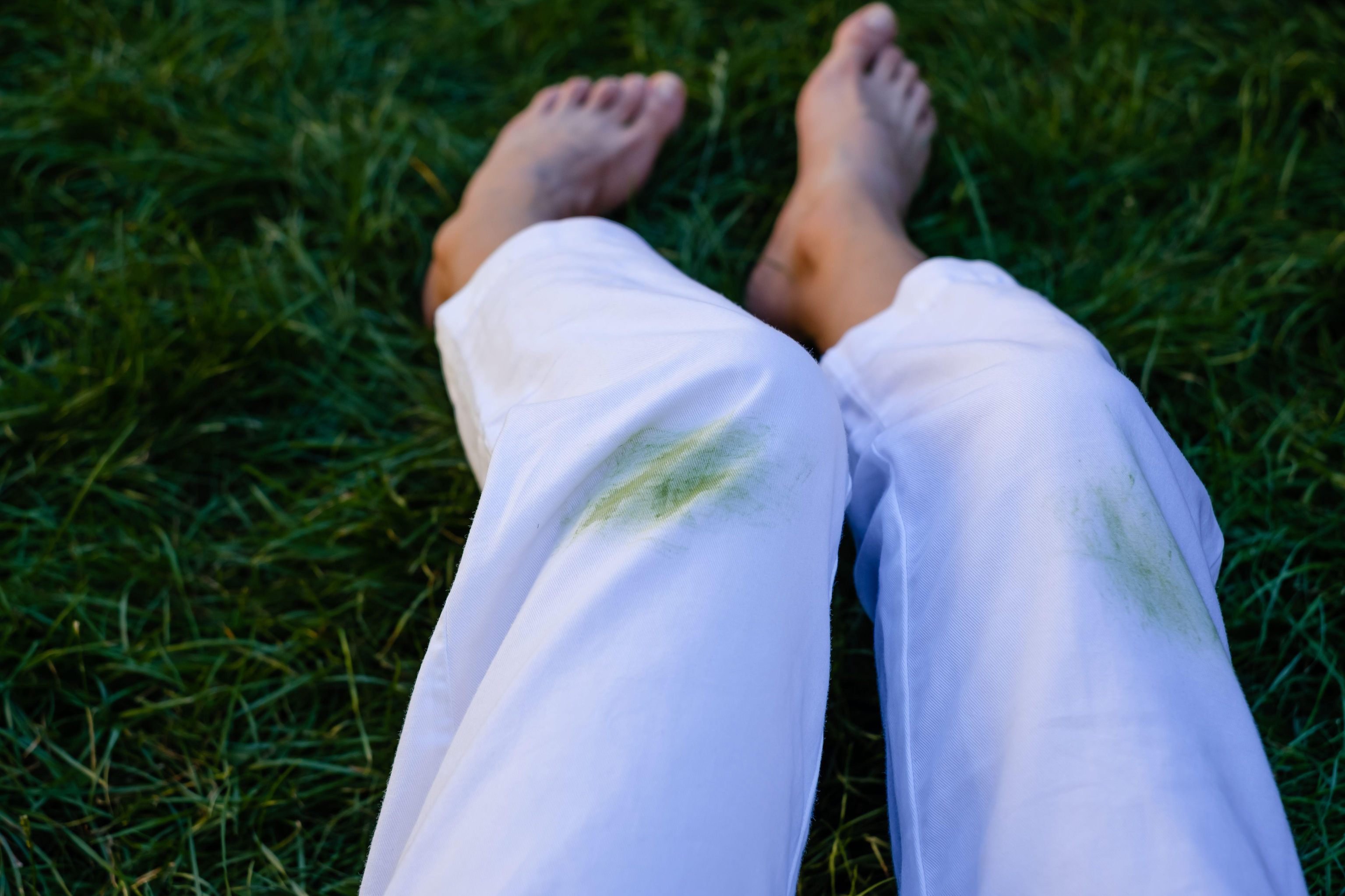 Woman with bare feet and grass stains on trousers