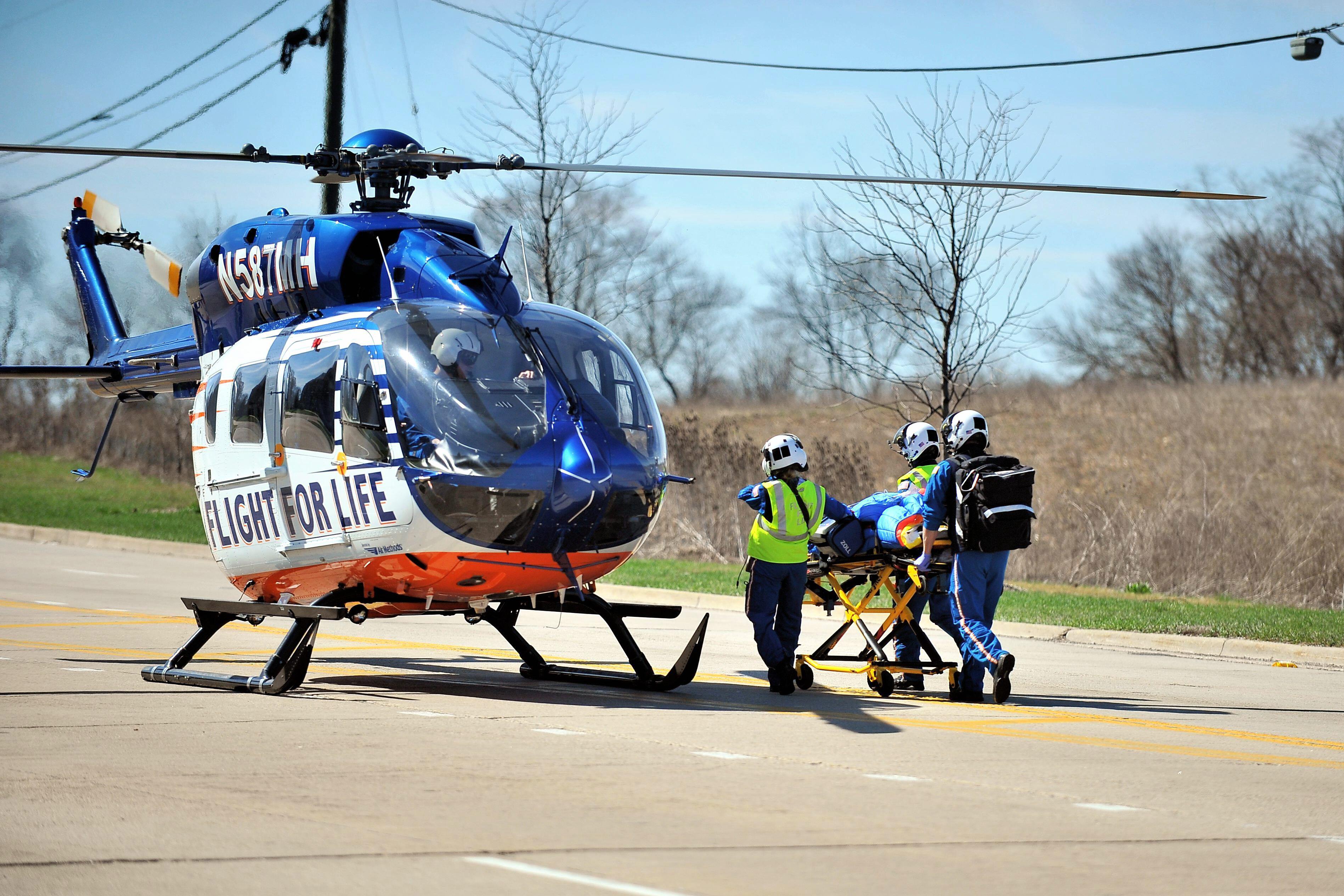 A medical helicopter picking up a patient who has been in a crash