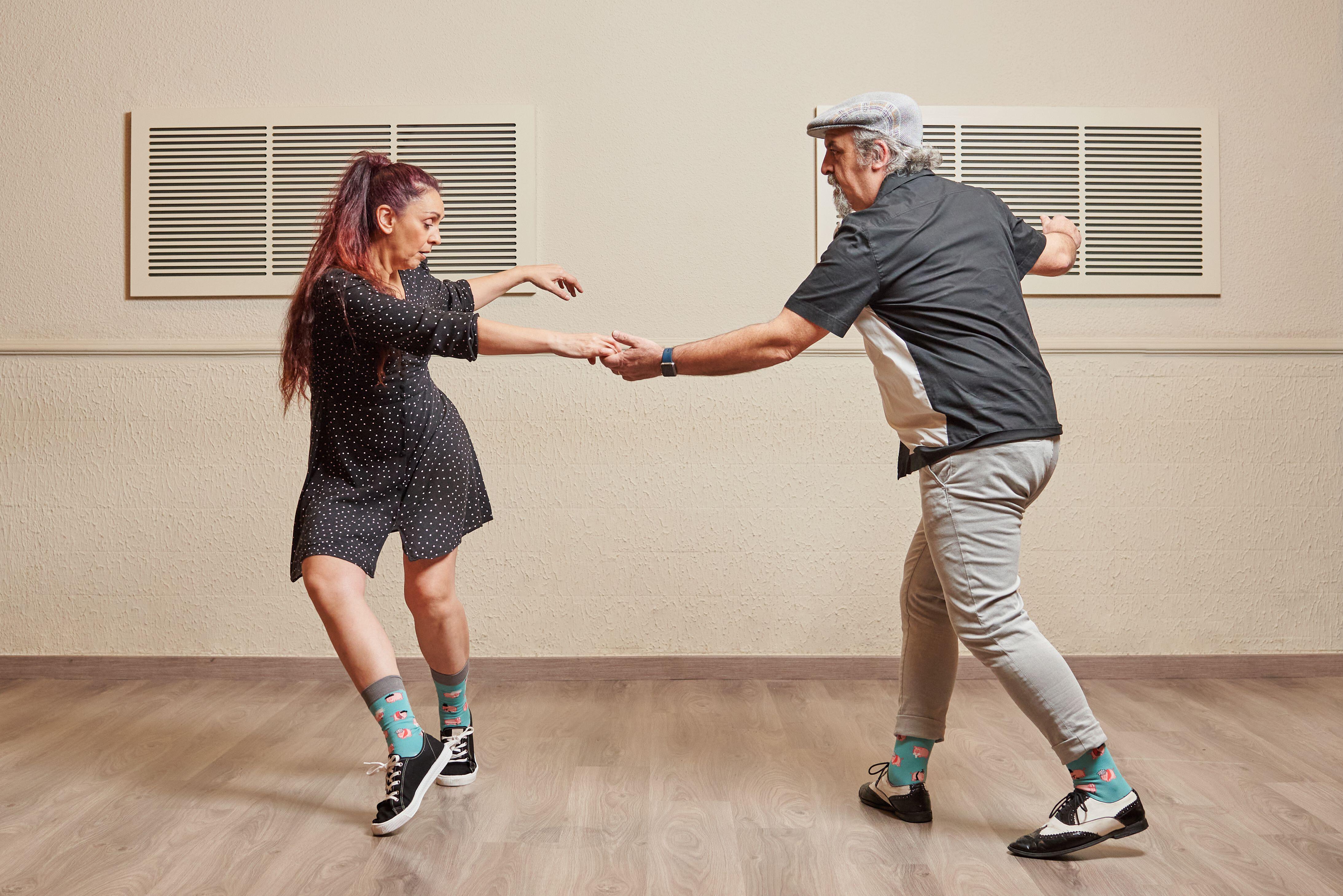 Dance couple doing a lindy hop dance move