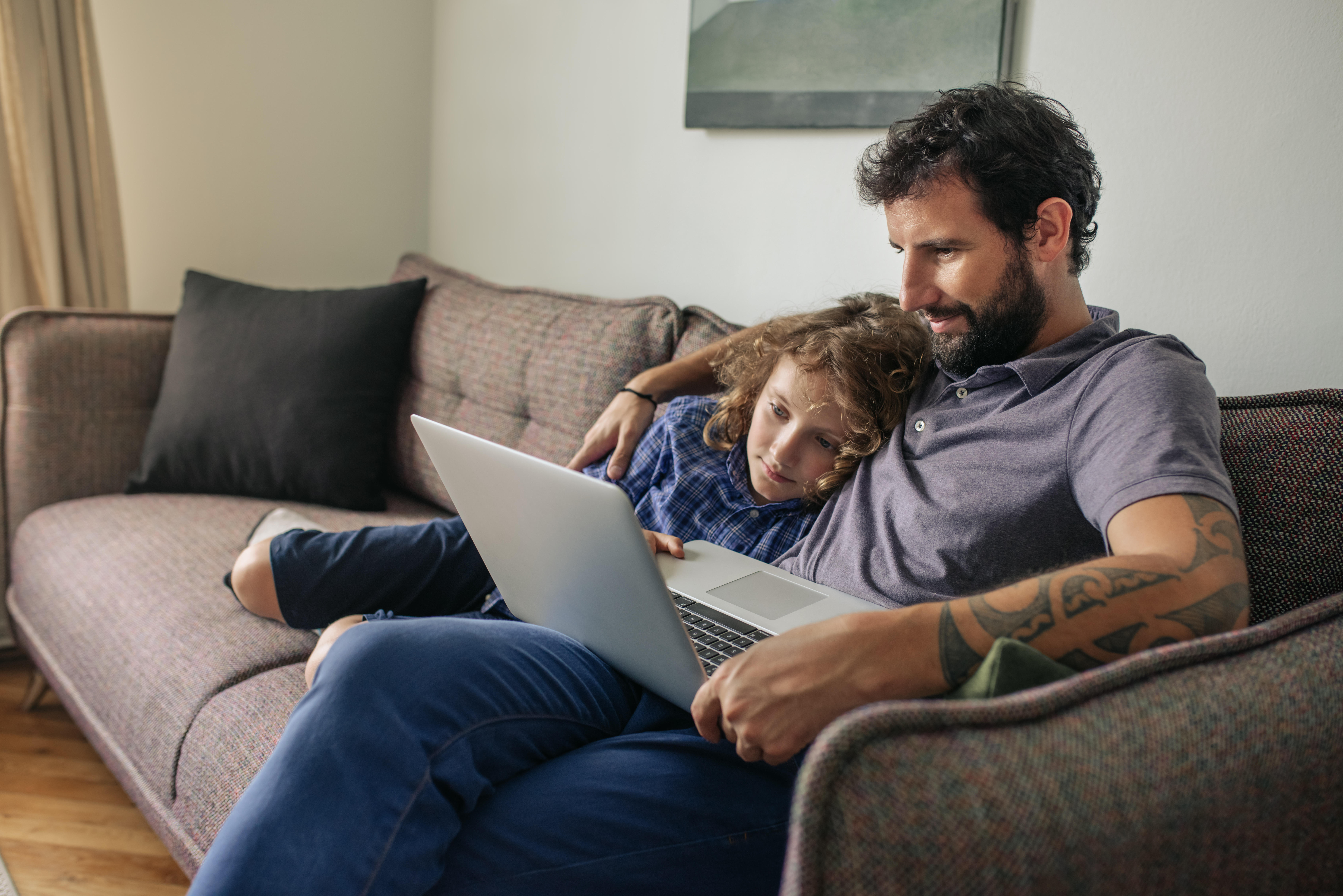 dad and child watching a movie on the laptop