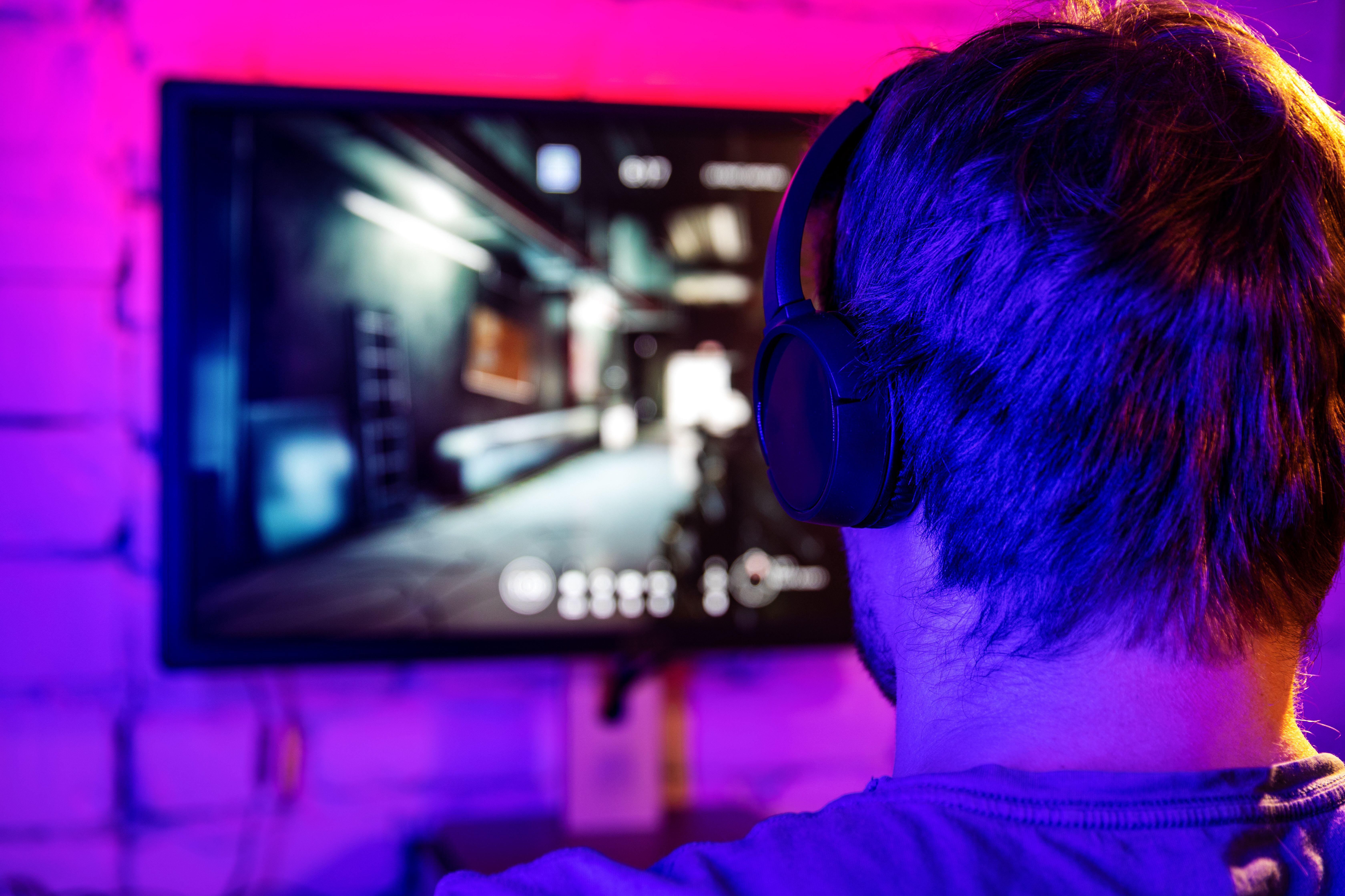 back of man's head playing online video games