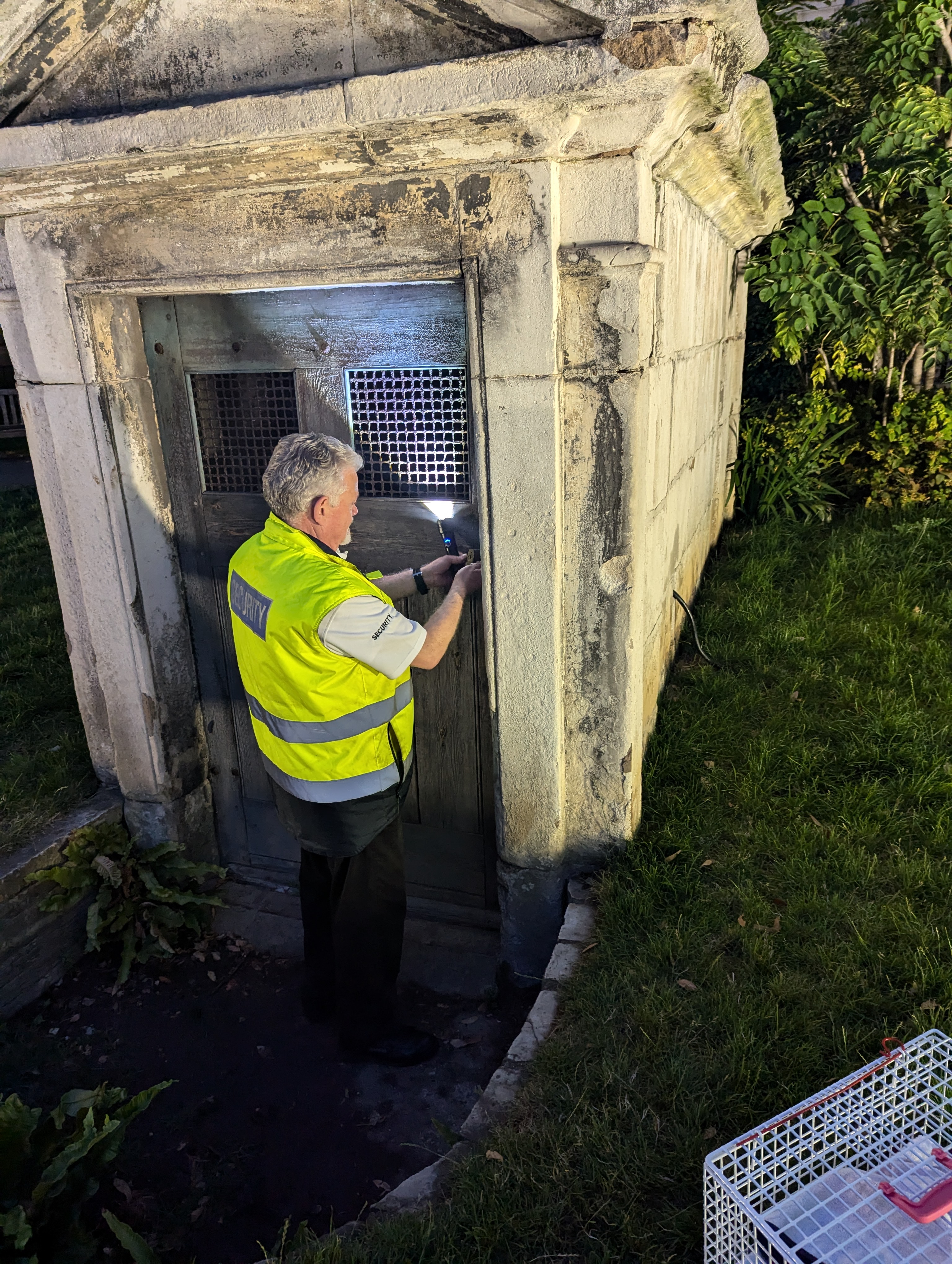 Man opening a door leading to a basement at St Paul's Cathedral