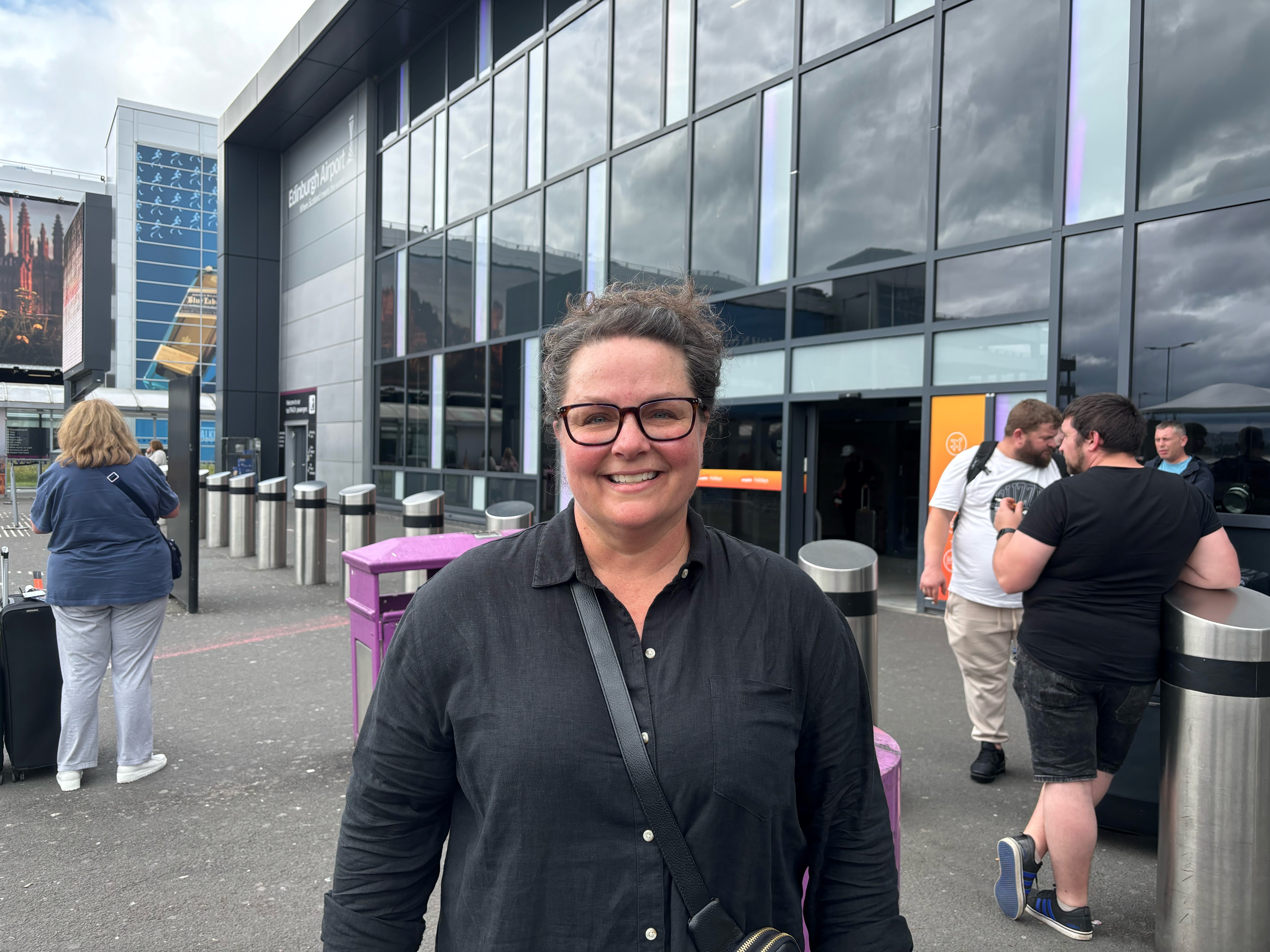 Stephanie Thompson smiling outside airport terminal