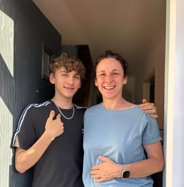 Teenager and woman standing together 