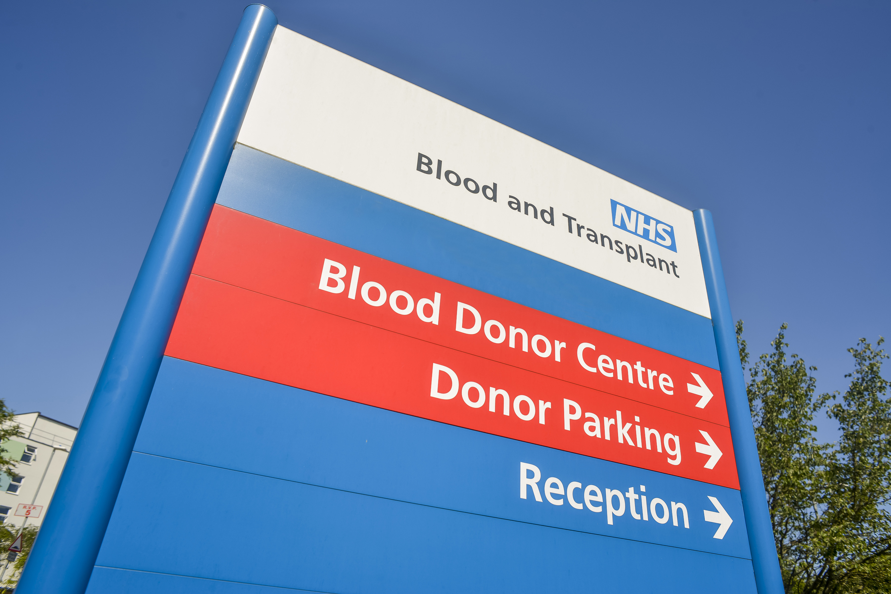 An NHS Blood and Transplant Blood donor centre sign with directional arrows to departments