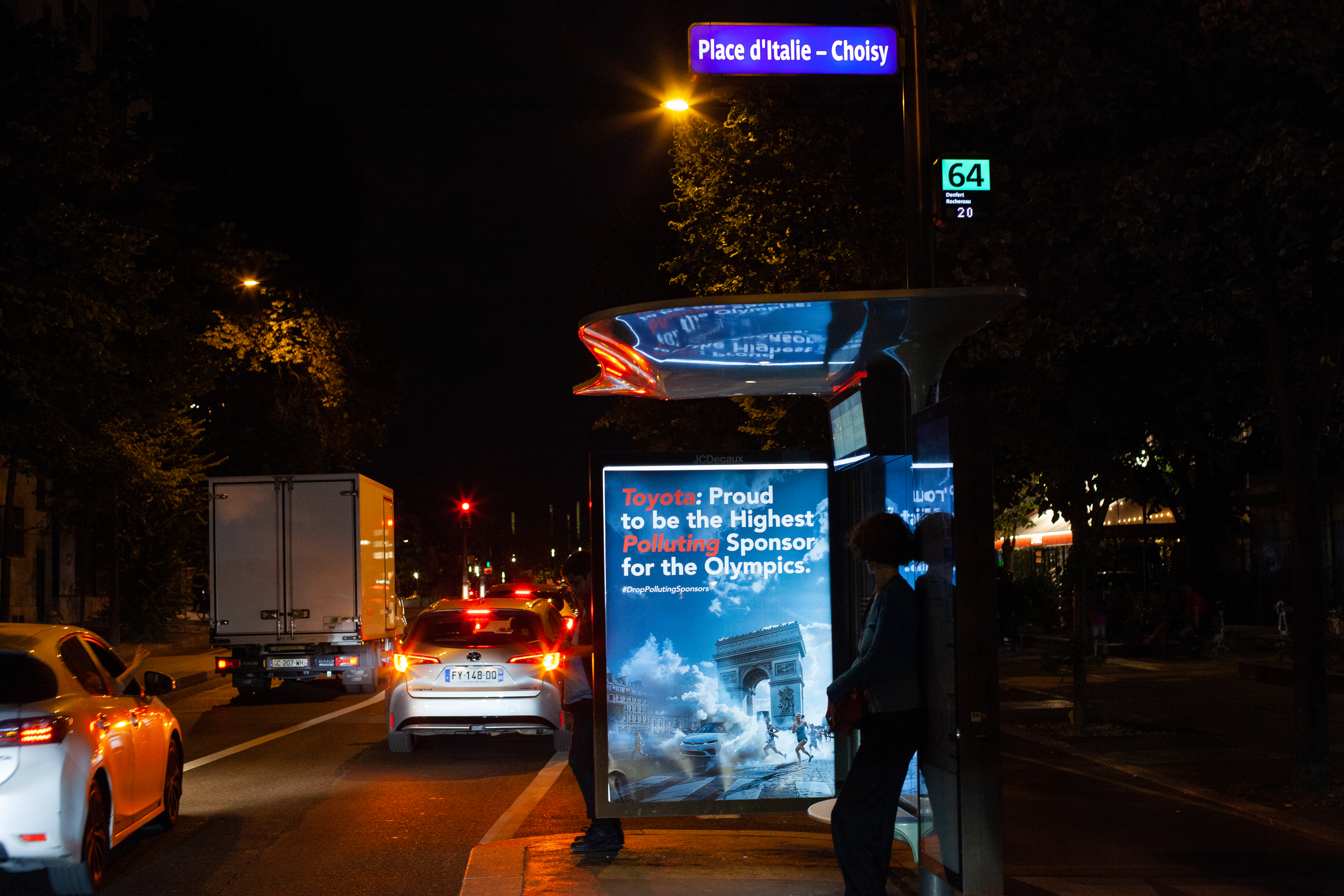A mock advert for Toyota in protest of its Paris 2024 sponsorship in a bus stop in Place d'Italie/Paris