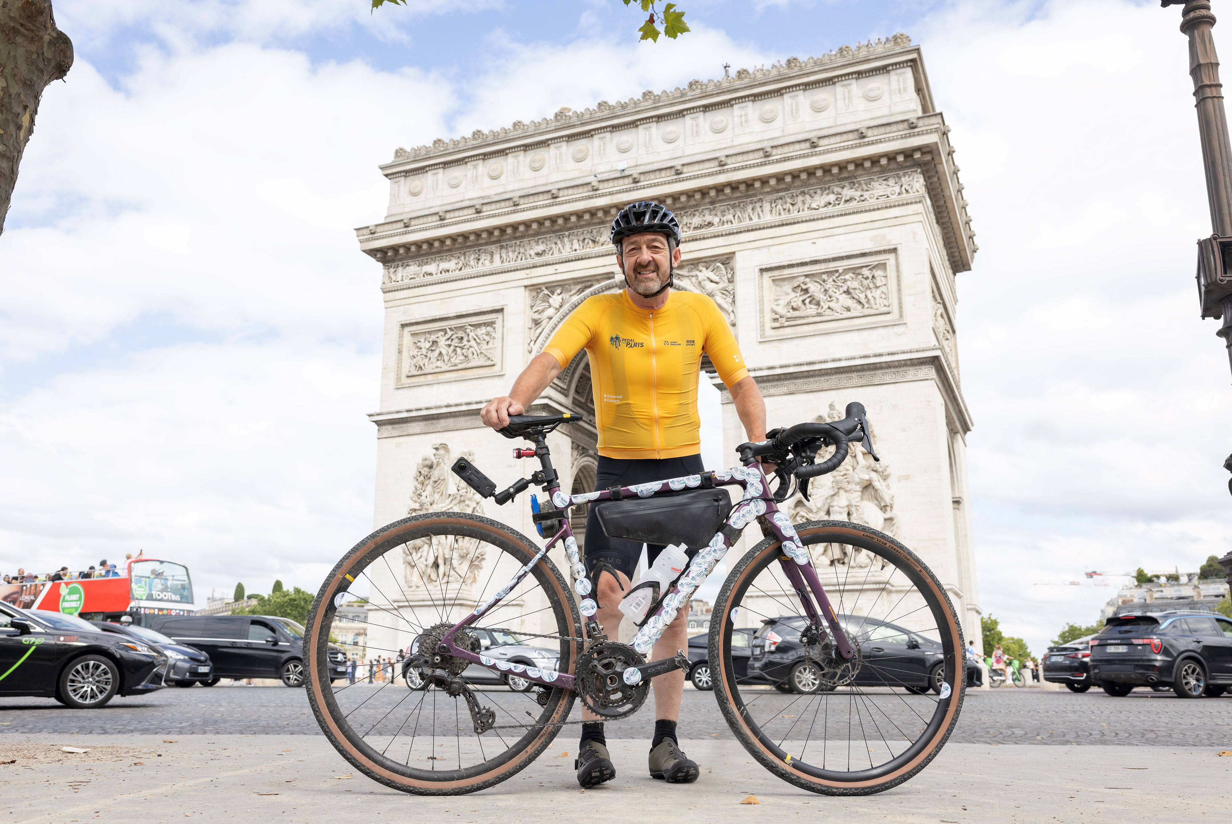 Olympic champion Chris Boardman poses with a bike by the Arc de Triomphe in Paris