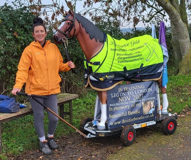 Woman standing with resin horse