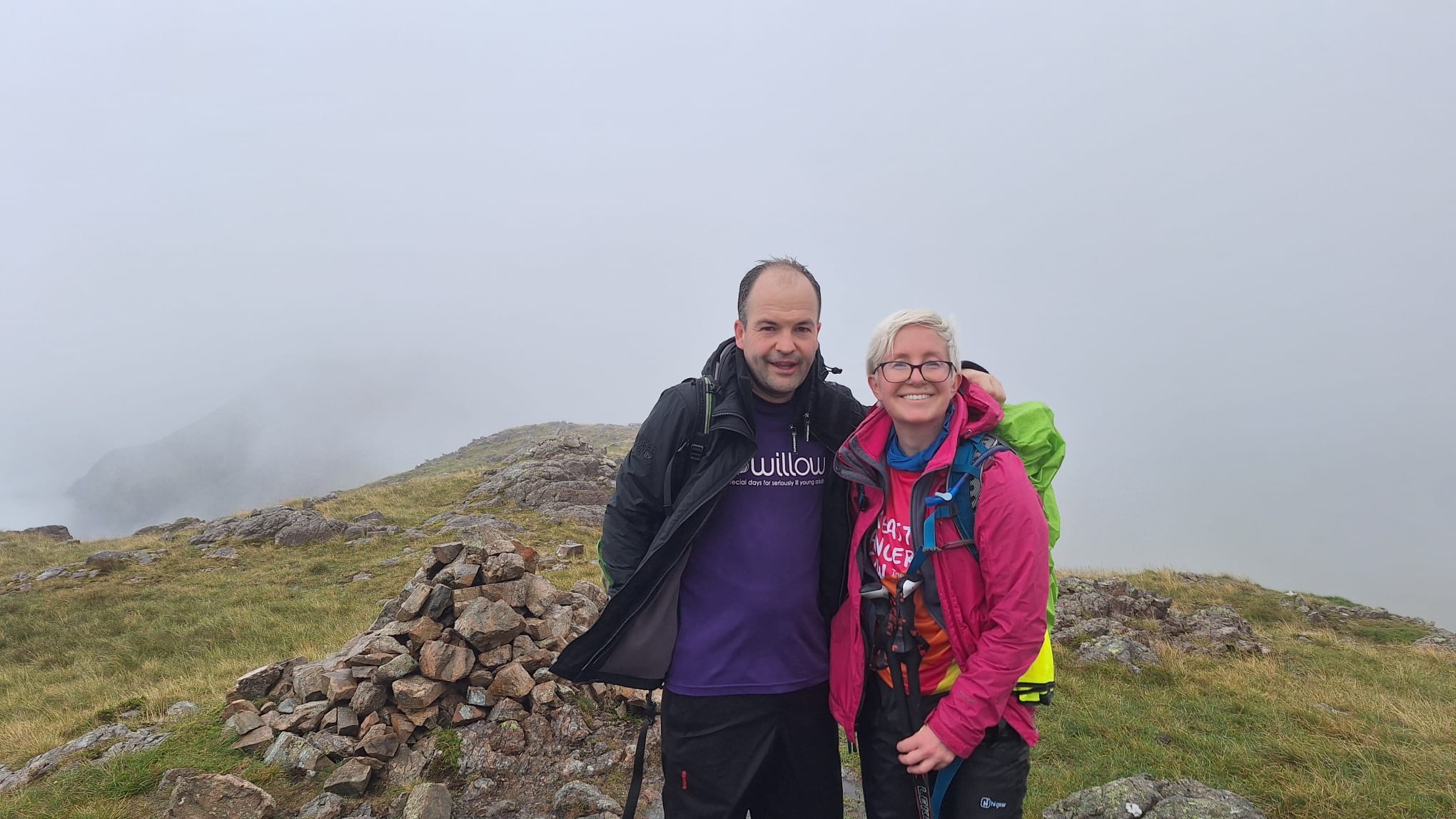 Jackie Scully with her husband Duncan Sloan standing on top of a peak in the Lake District