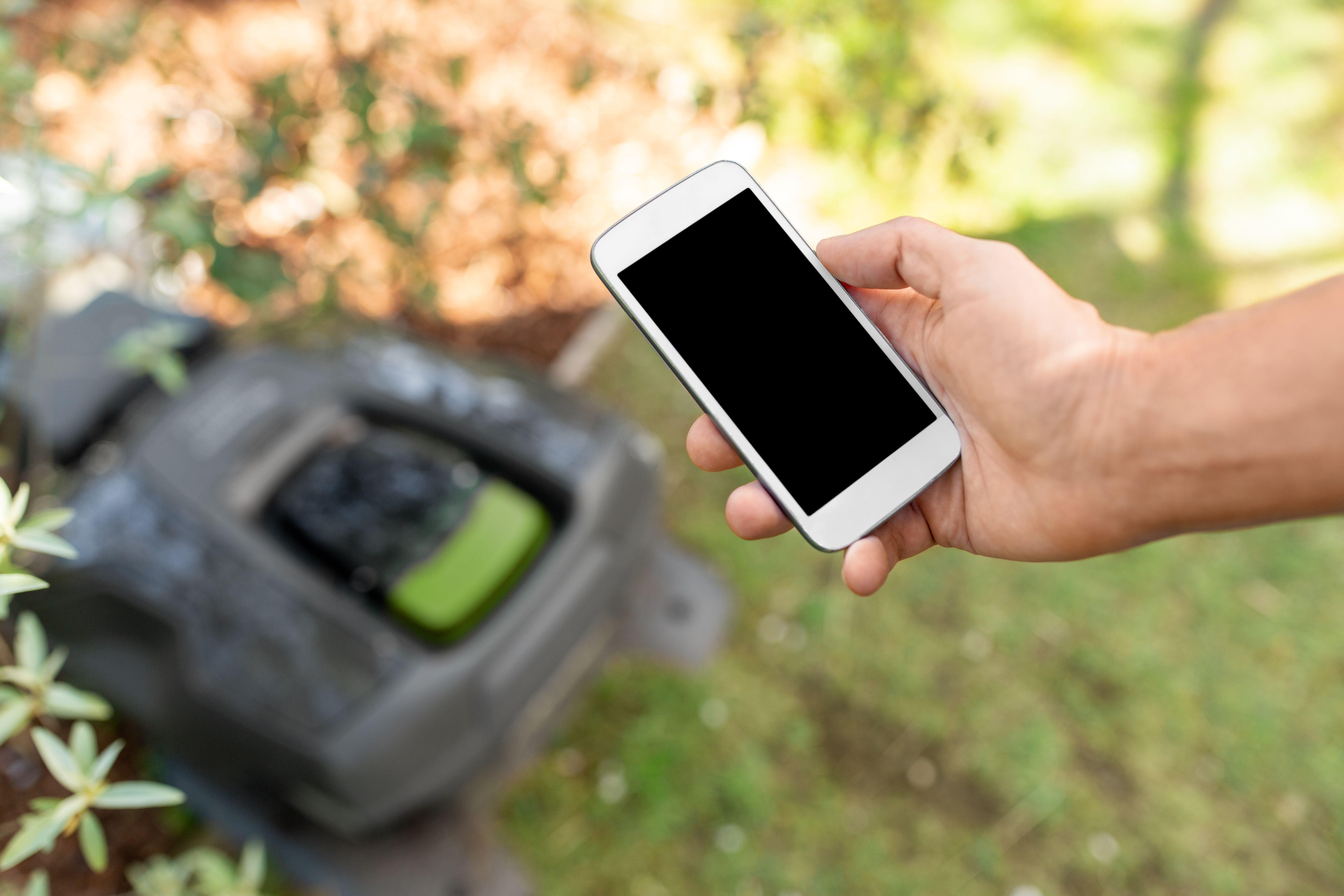 A smartphone connected to a robot lawnmower