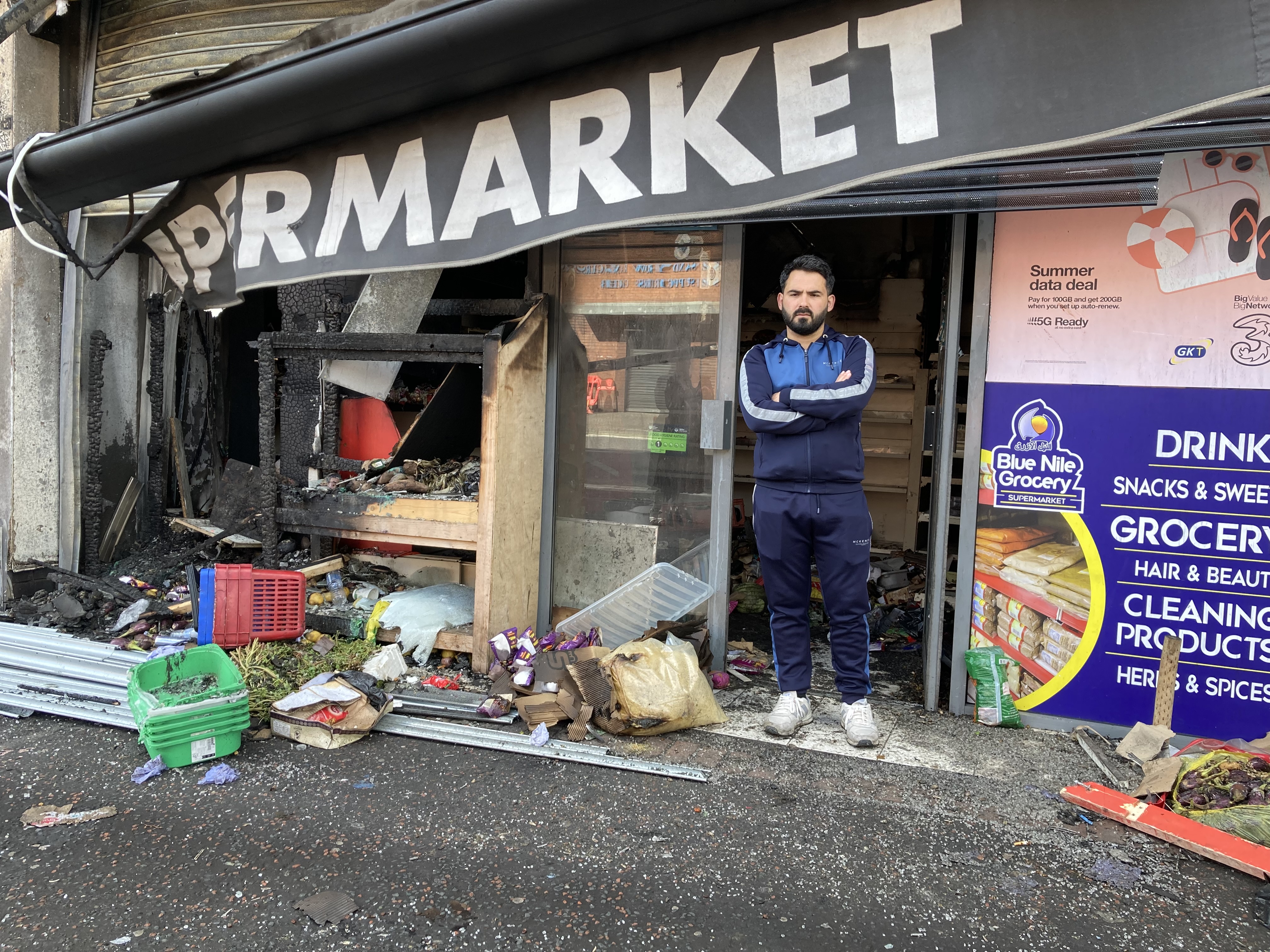 Man outside destroyed supermarket