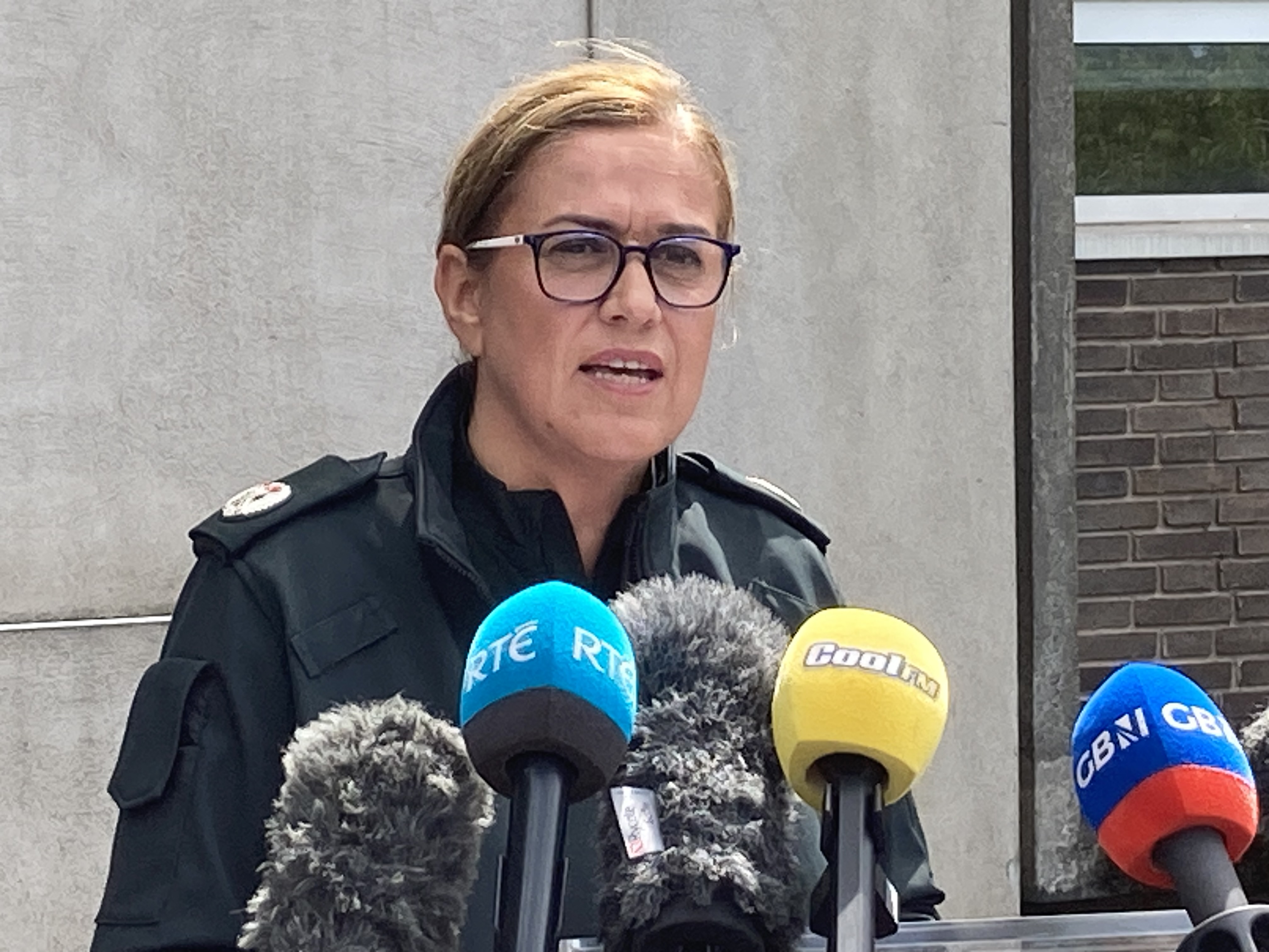 Broadcast microphones in front of Assistant Chief Constable Melanie Jones