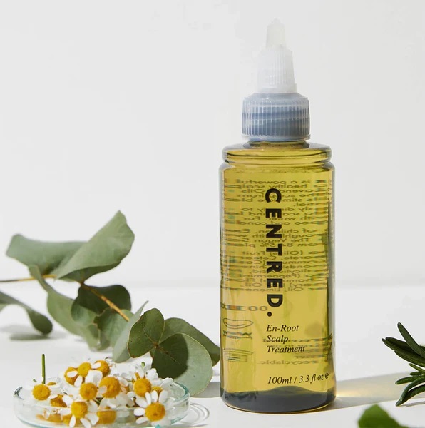 Clear bottle of golden soothing detoxifying scalp oil