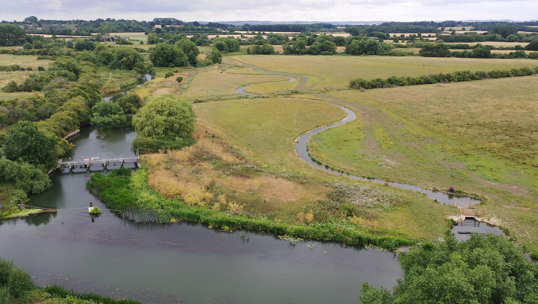 Aerial view of river restoration, including stream meandering through fields