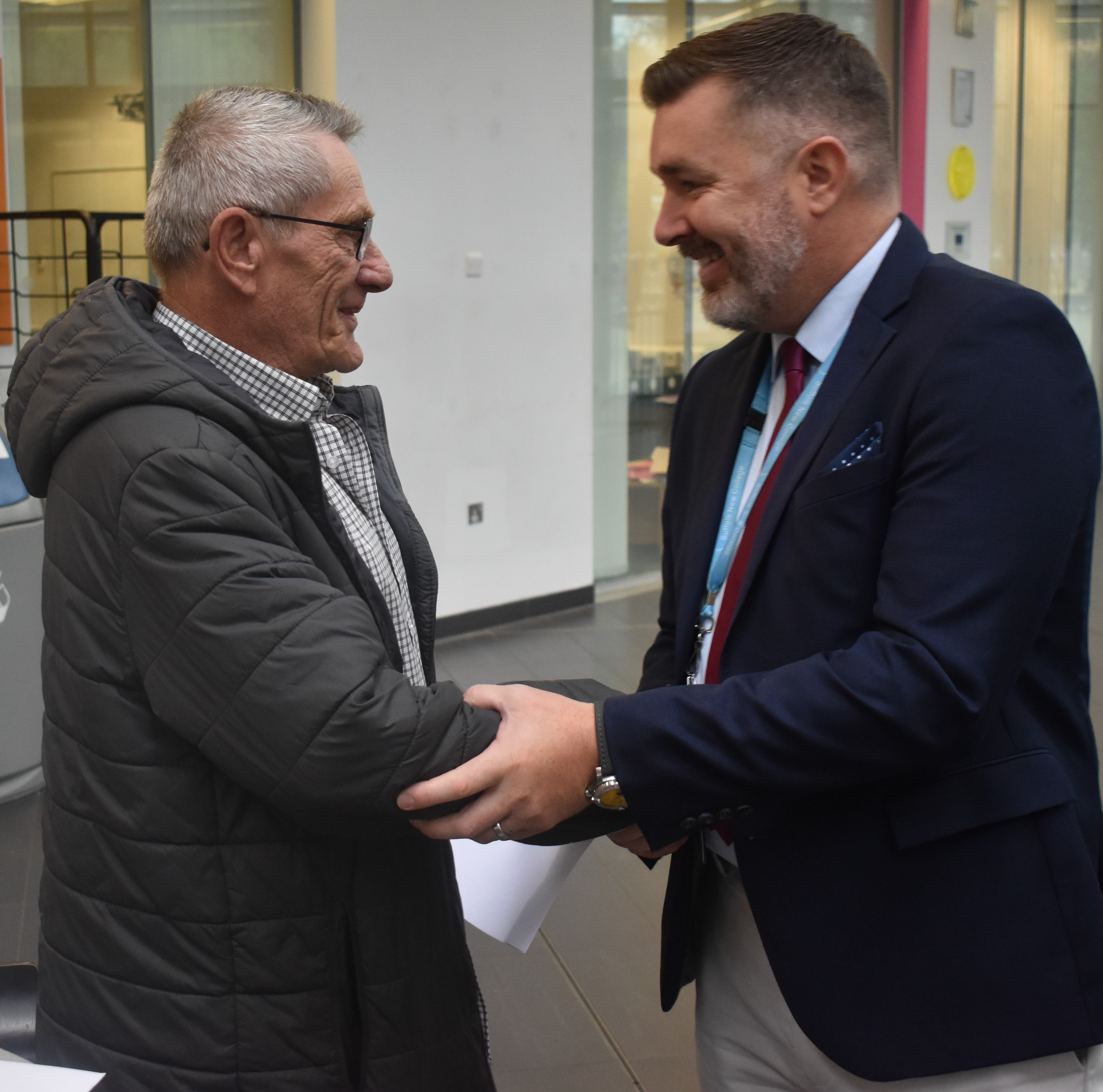 Danny Davey is congratulated by Suffolk New College Principal and CEO Alan Pease, having achieved a GCSE in English aged 73. (Suffolk New College/ PA)