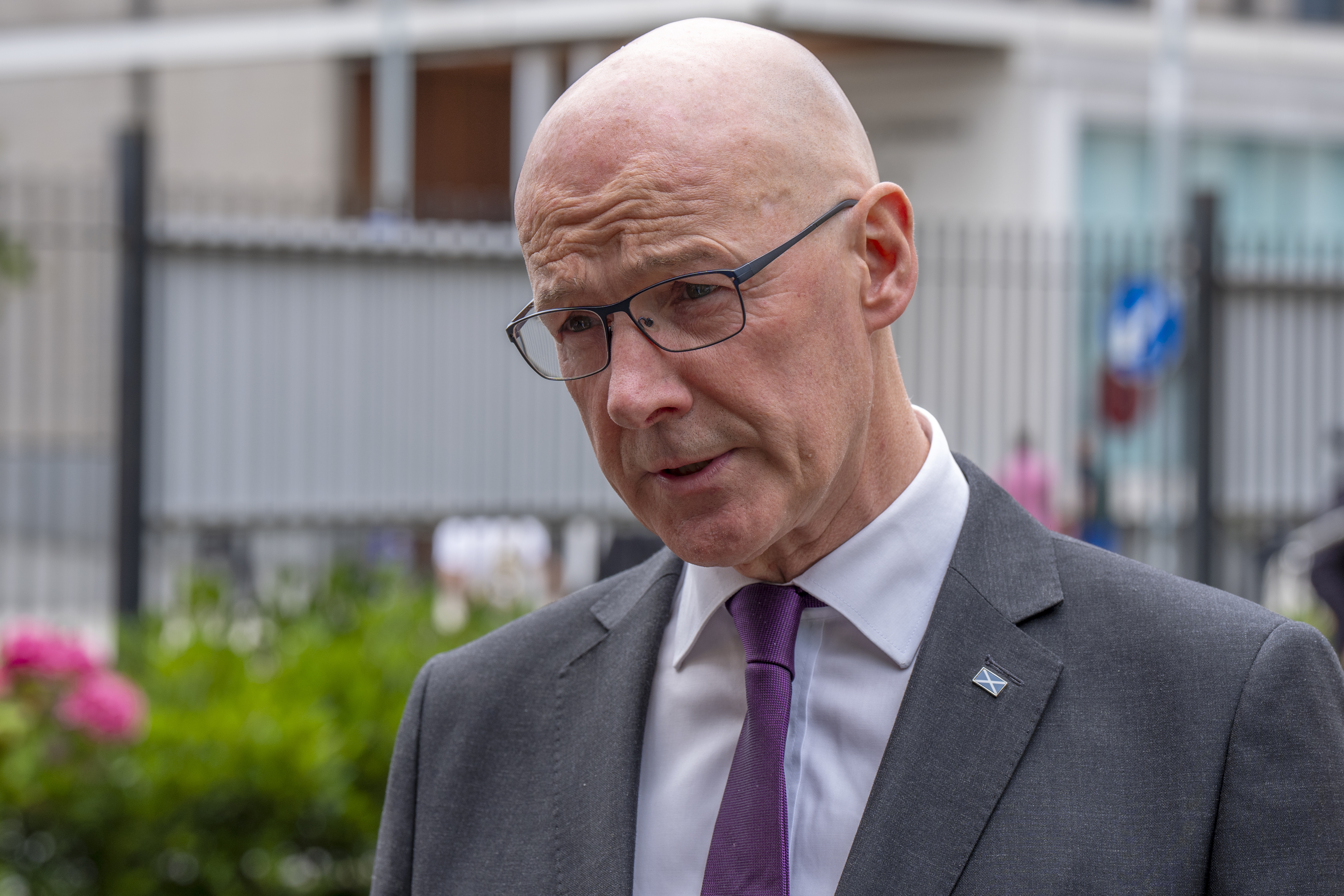 Head and shoulders photo of John Swinney speaking outside a building