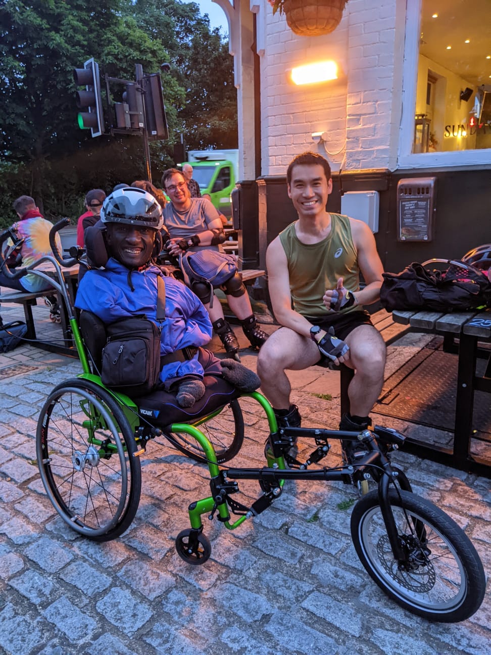 Man in wheelchair next to man sitting down 