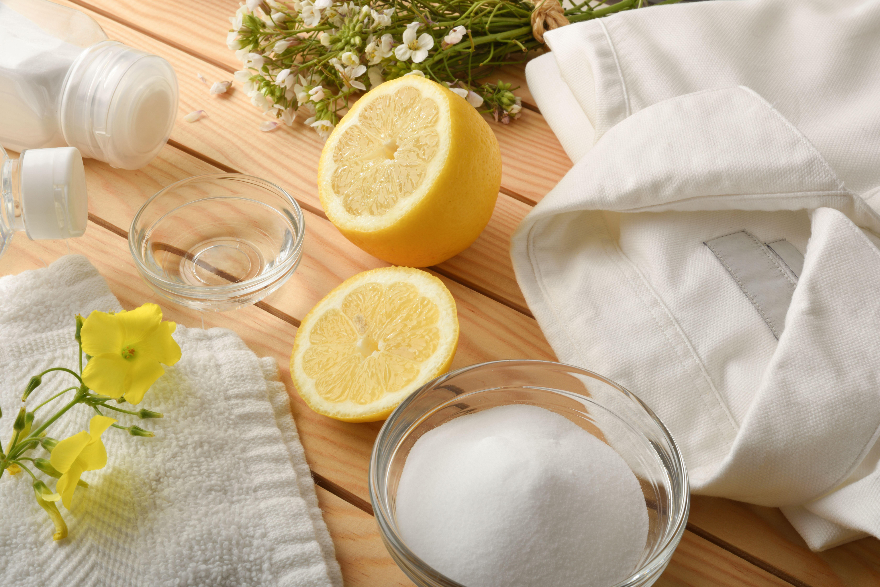 Halved lemon with white shirt for stain removal and eco-cleaning 