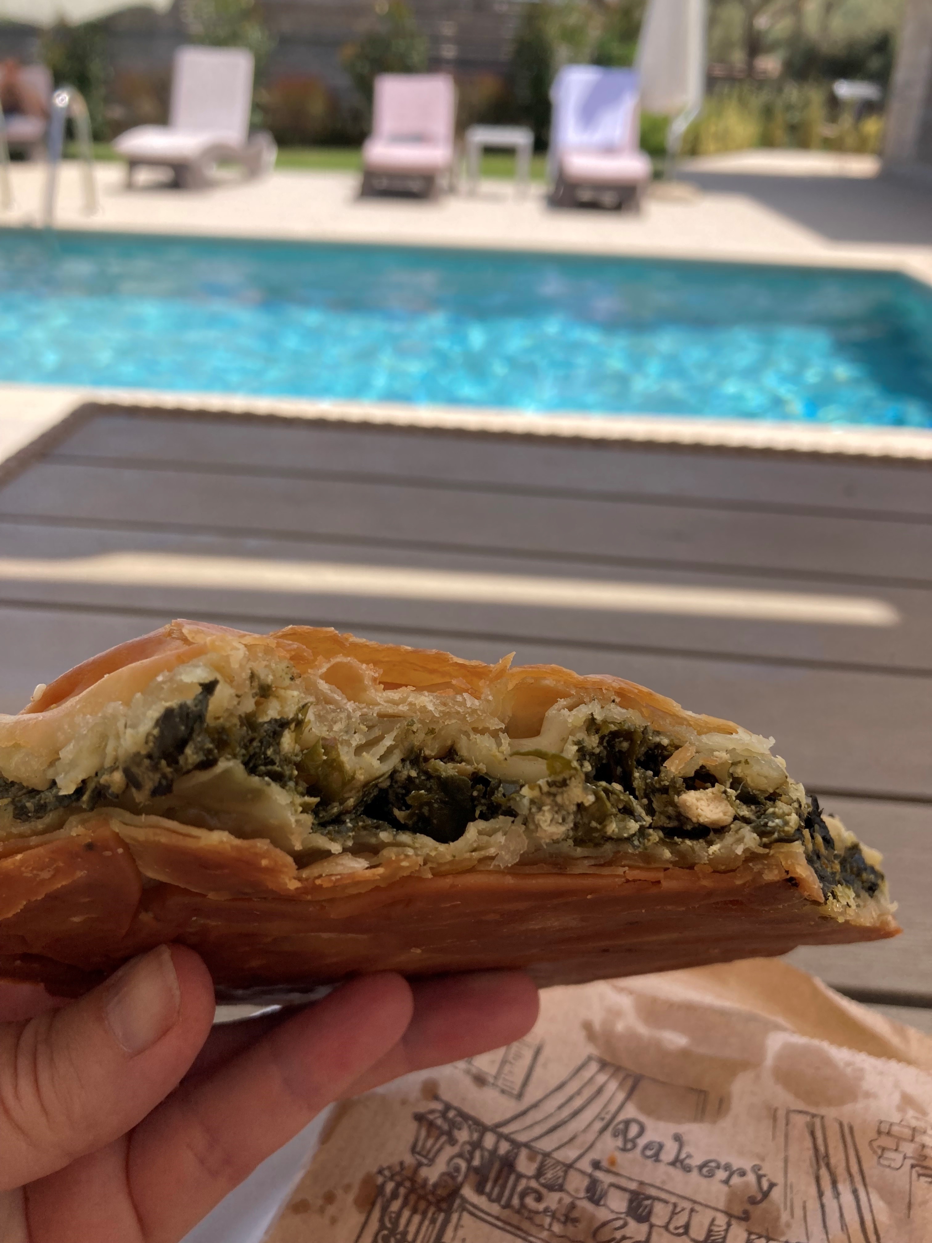 Tucking into spanakopita by the pool in Lefkada (Hannah Stephenson/PA)