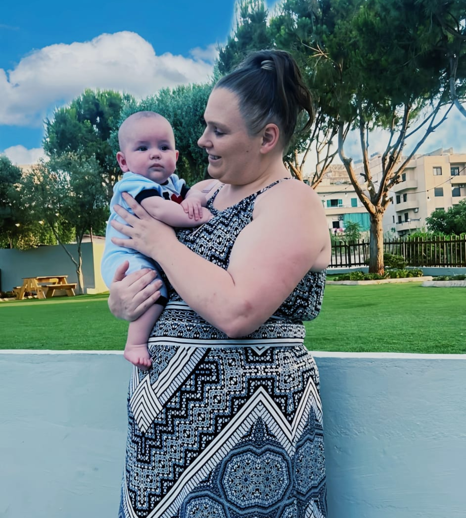 Navana Mayhew holding a baby