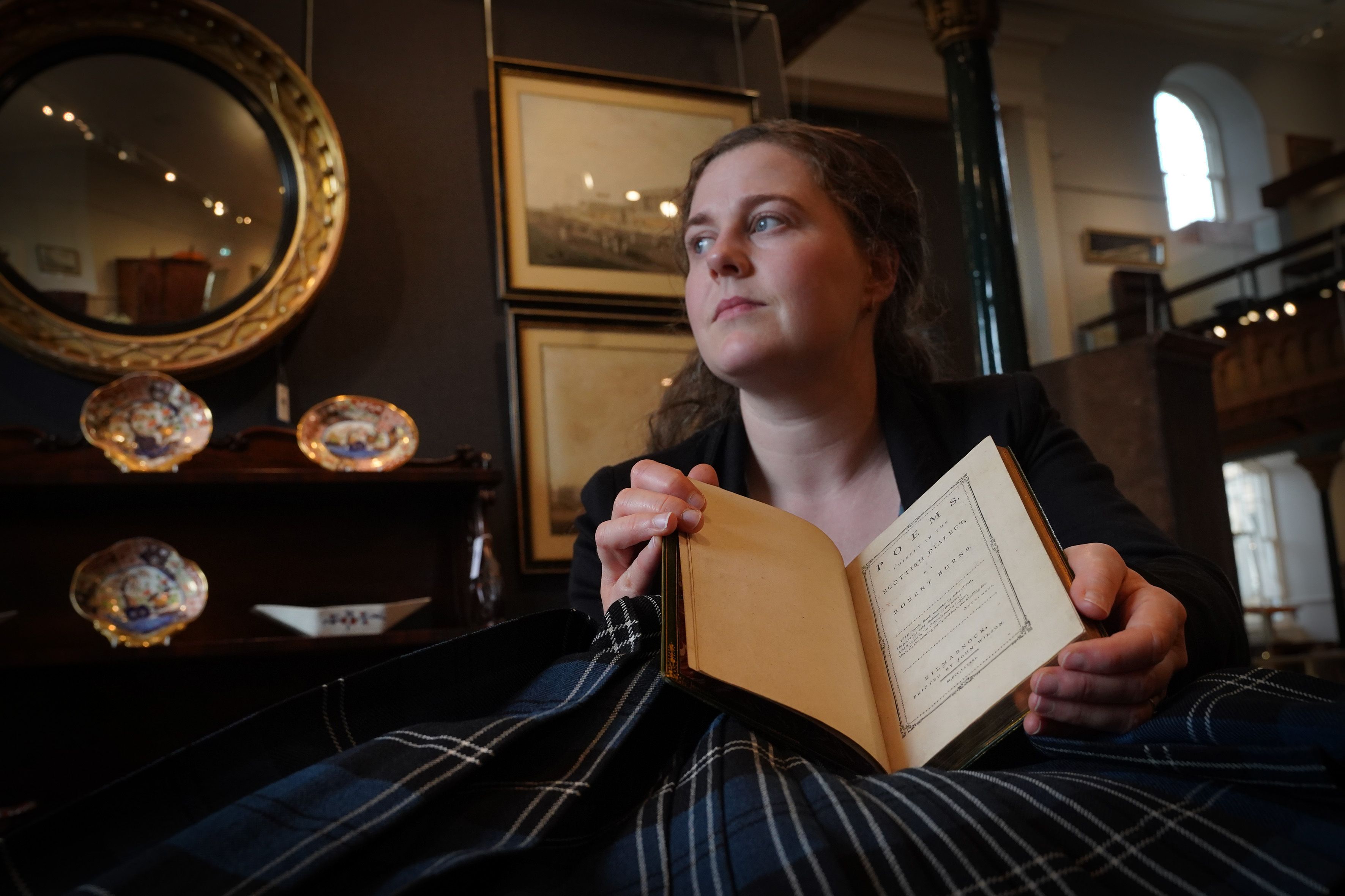 Cathy Marsden holding the book open