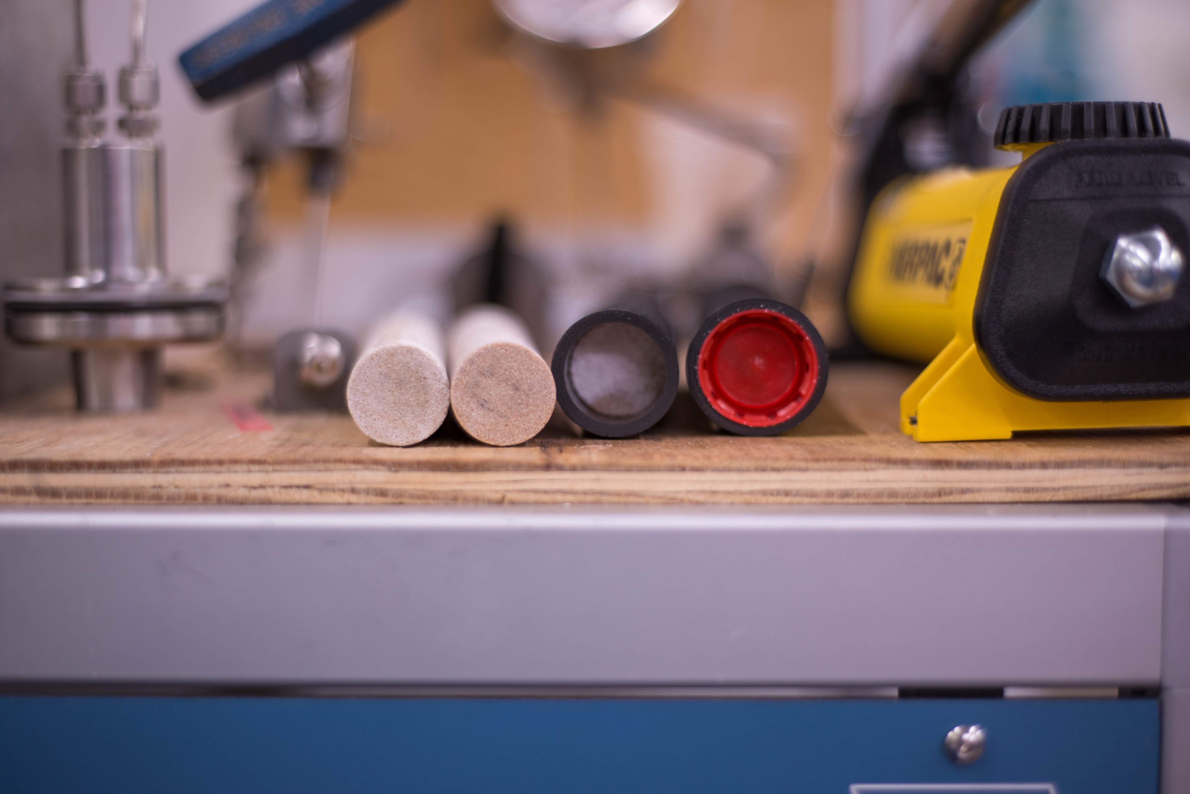 Samples of rock on a workbench next to some tools