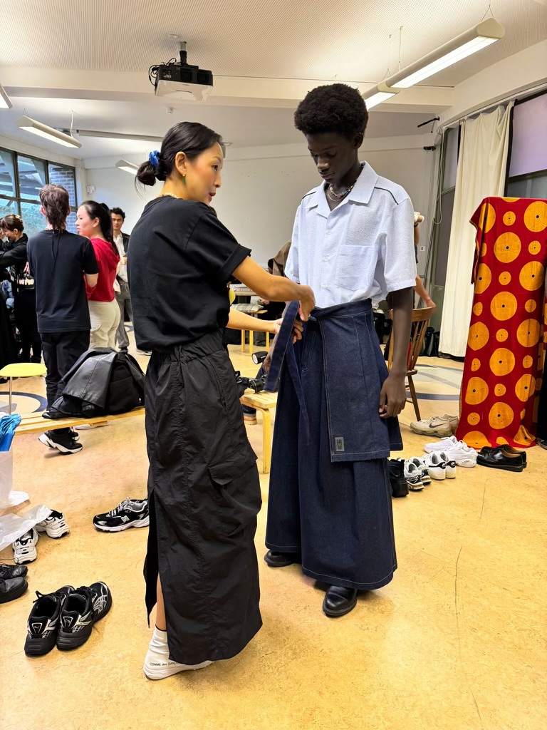 Fashion designer sorting a model's clothing