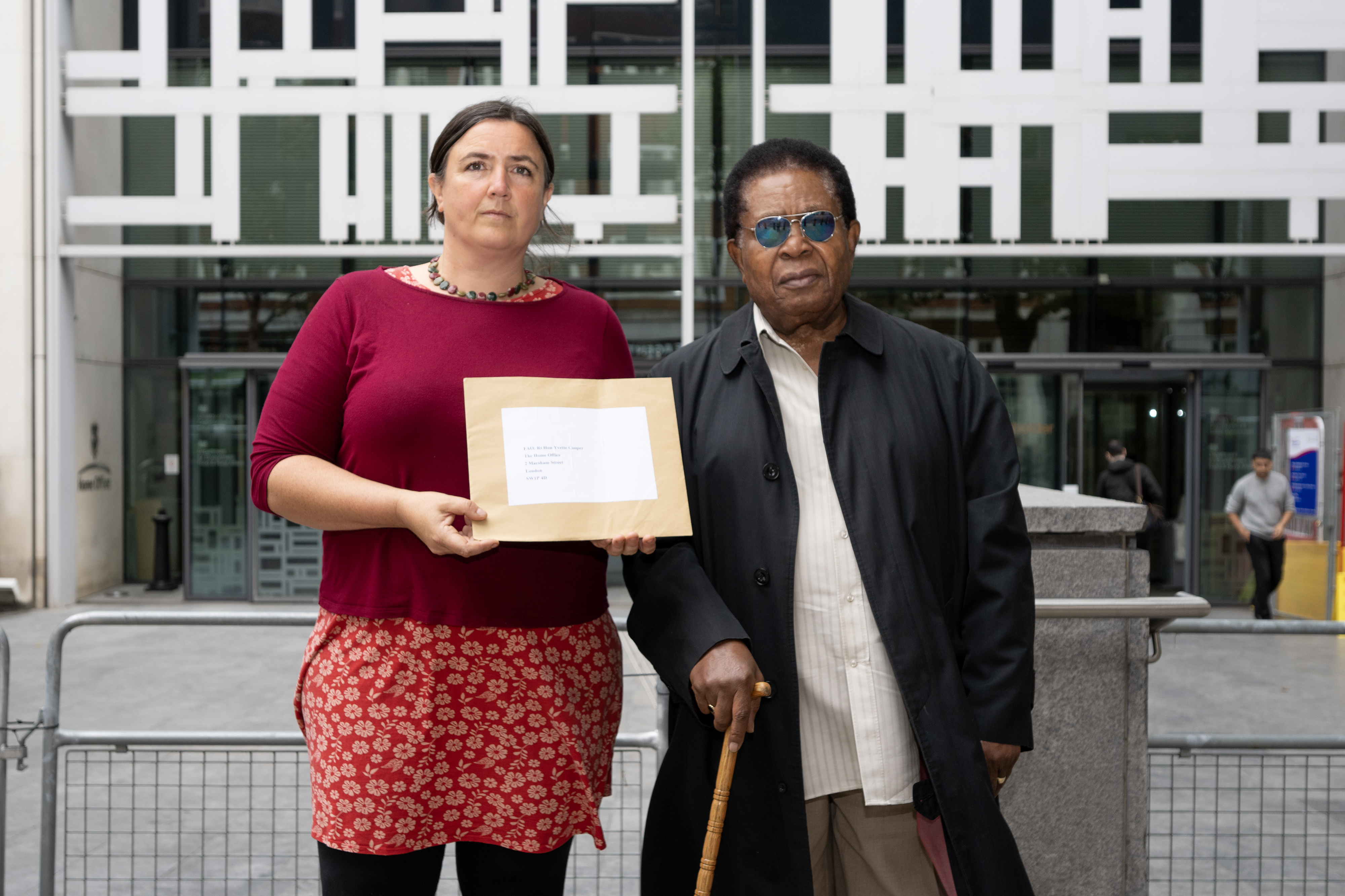 Eleanor Fairbraida and John Burke-Monerville standing outside the Home Office