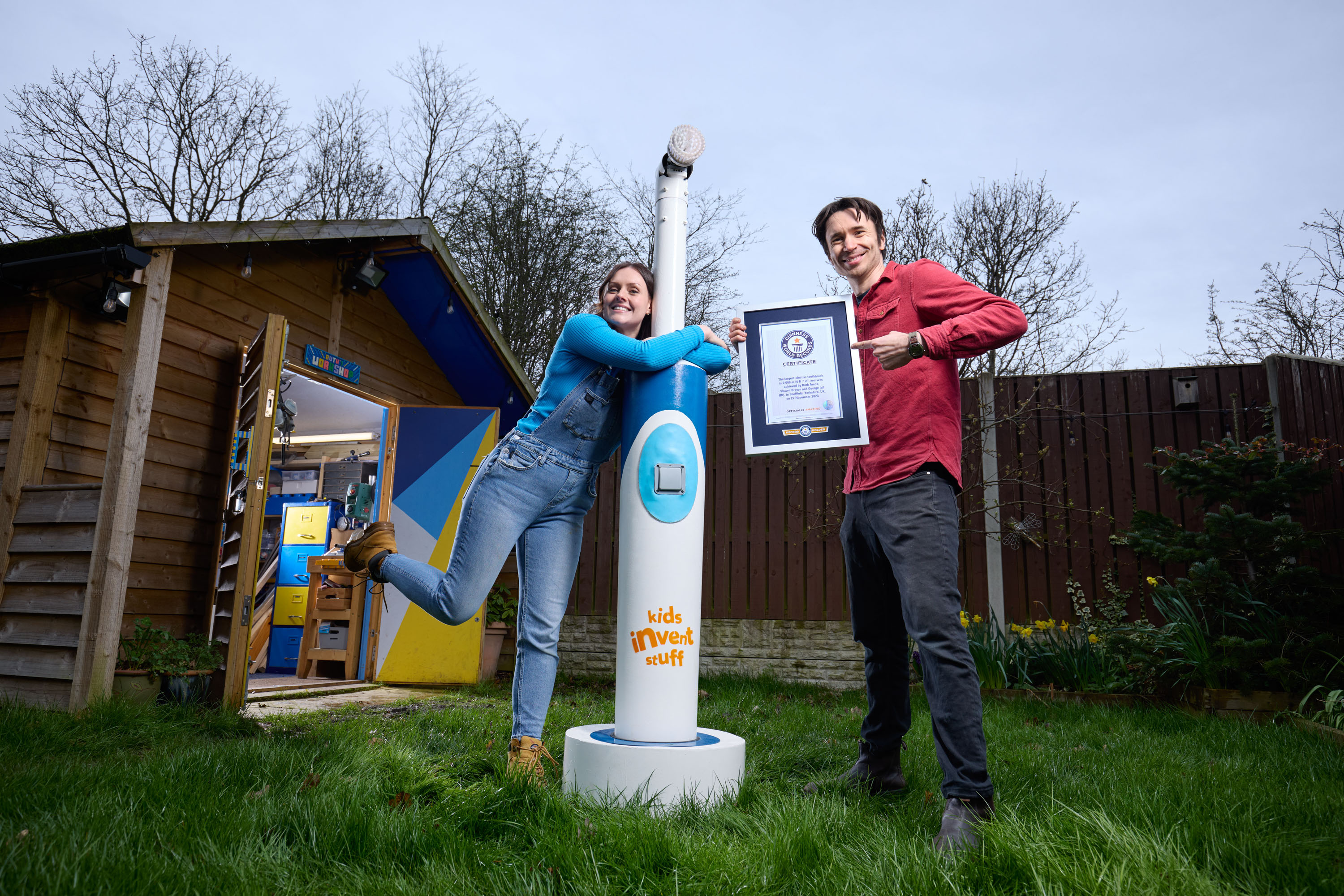 Ruth Amos and Shawn Brown pose with a huge electric toothbrush