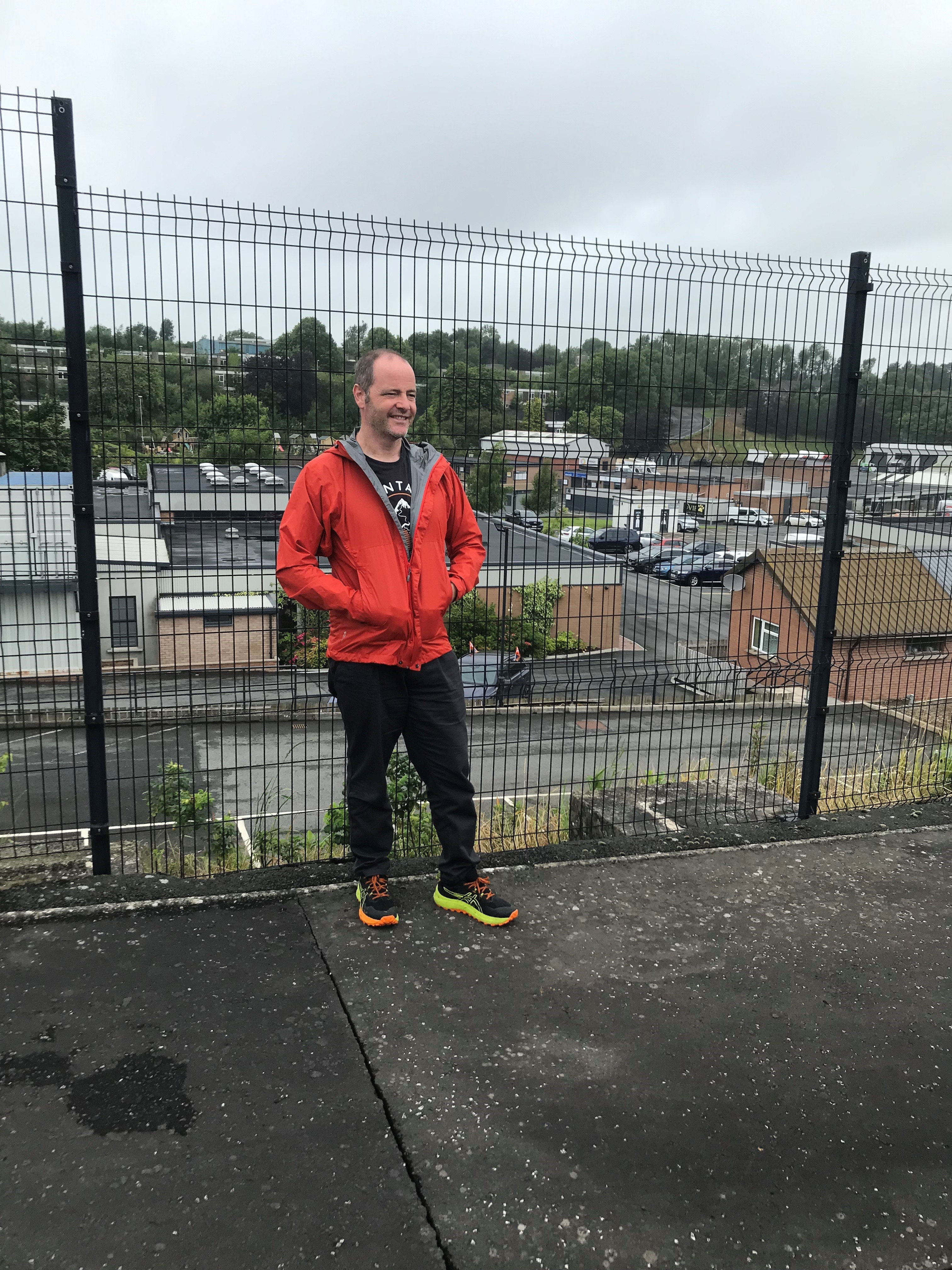 Rob Hughes smiling next to a fence