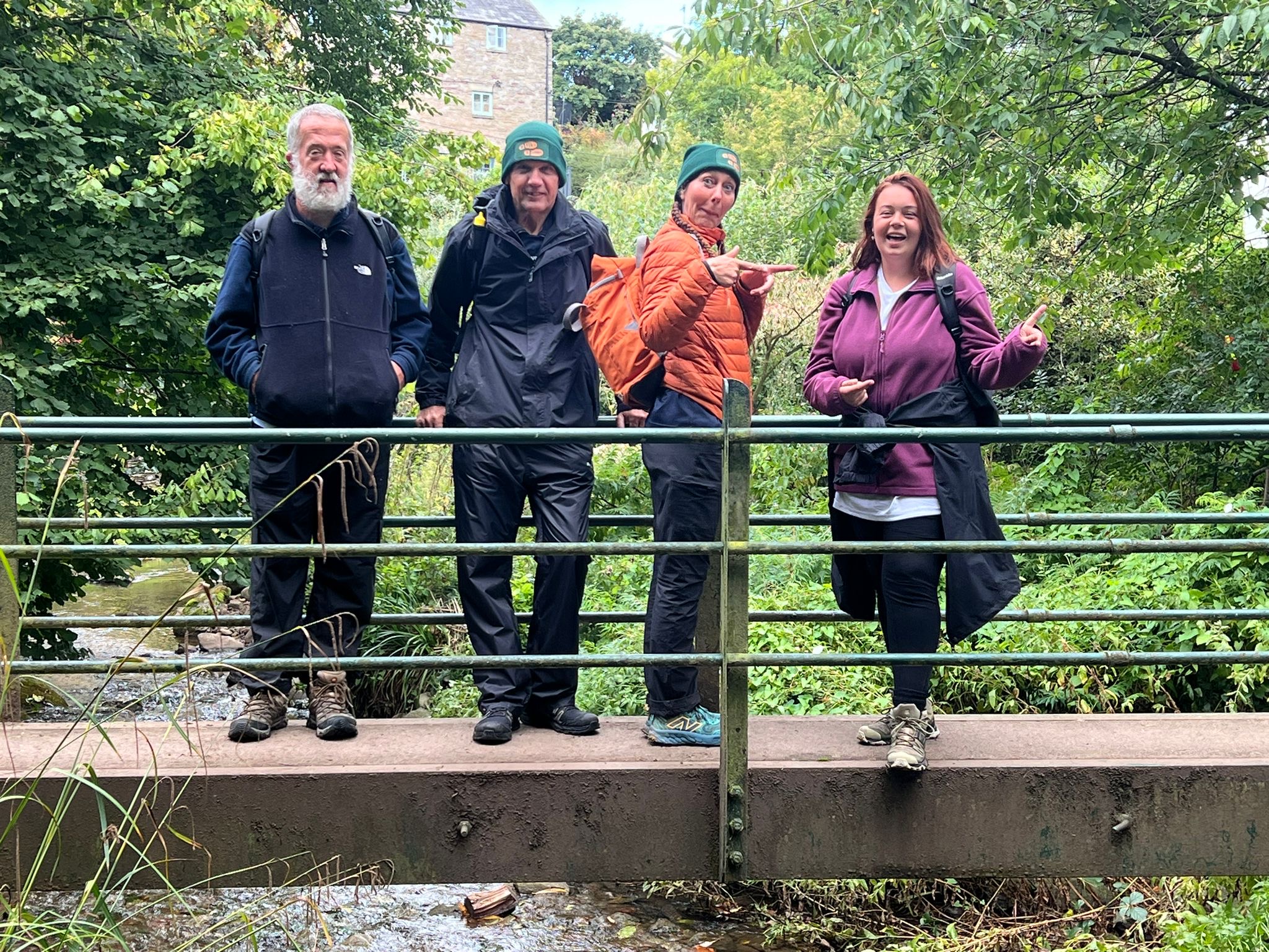 The group, pictured crossing the border into England, are more than halfway into their epic fundraising walk