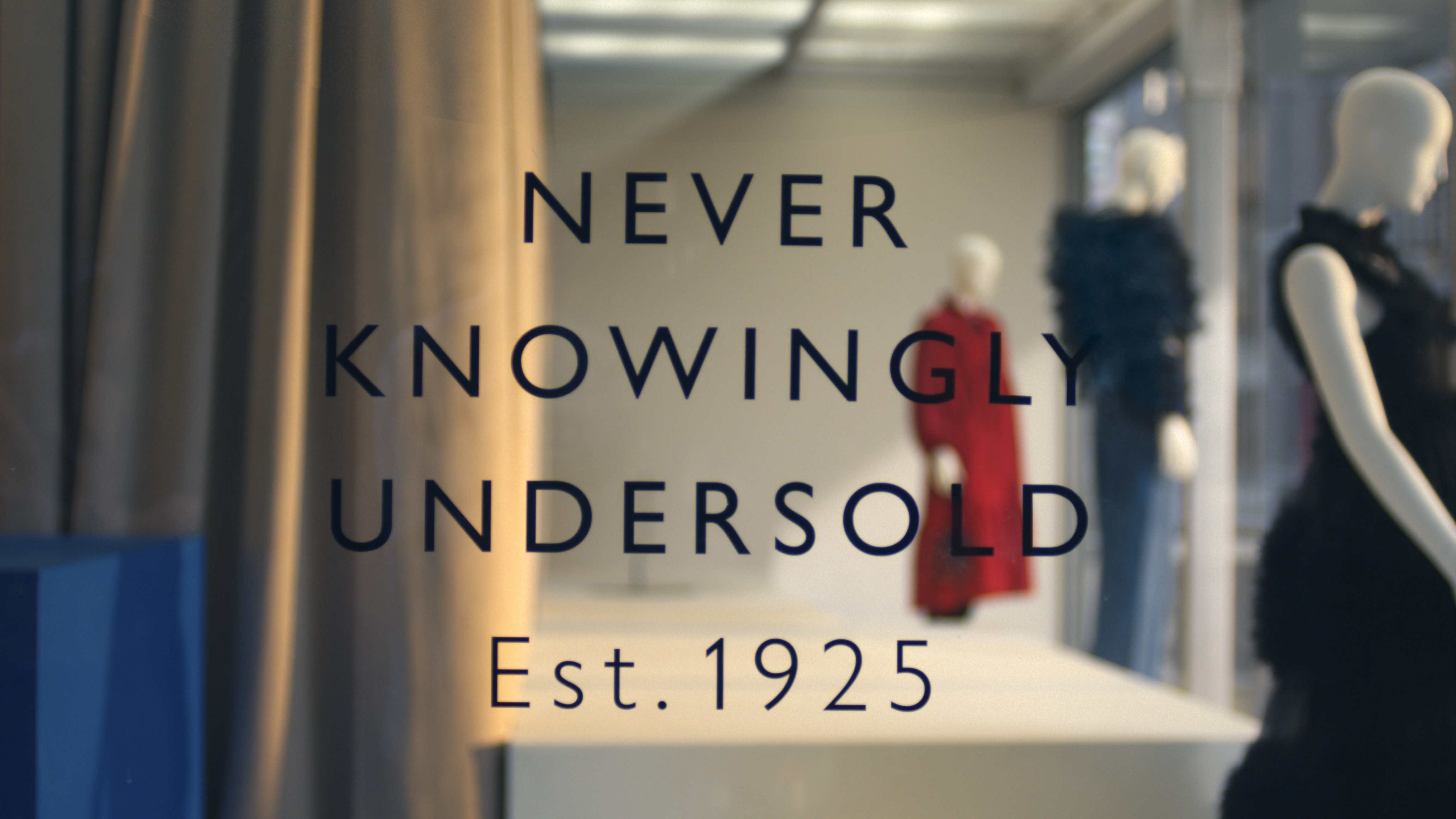 A still from the John Lewis ad showing its Never Knowingly Undersold pledge on a store window