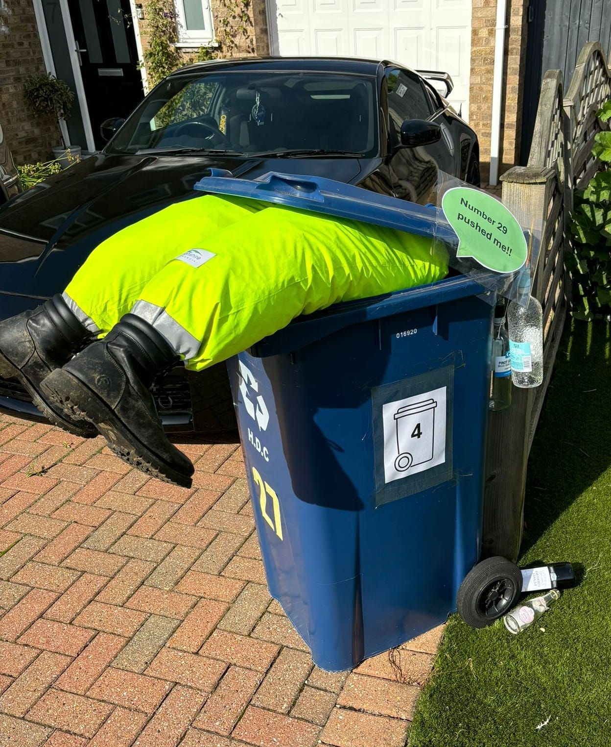 Scarecrow hanging out of bin