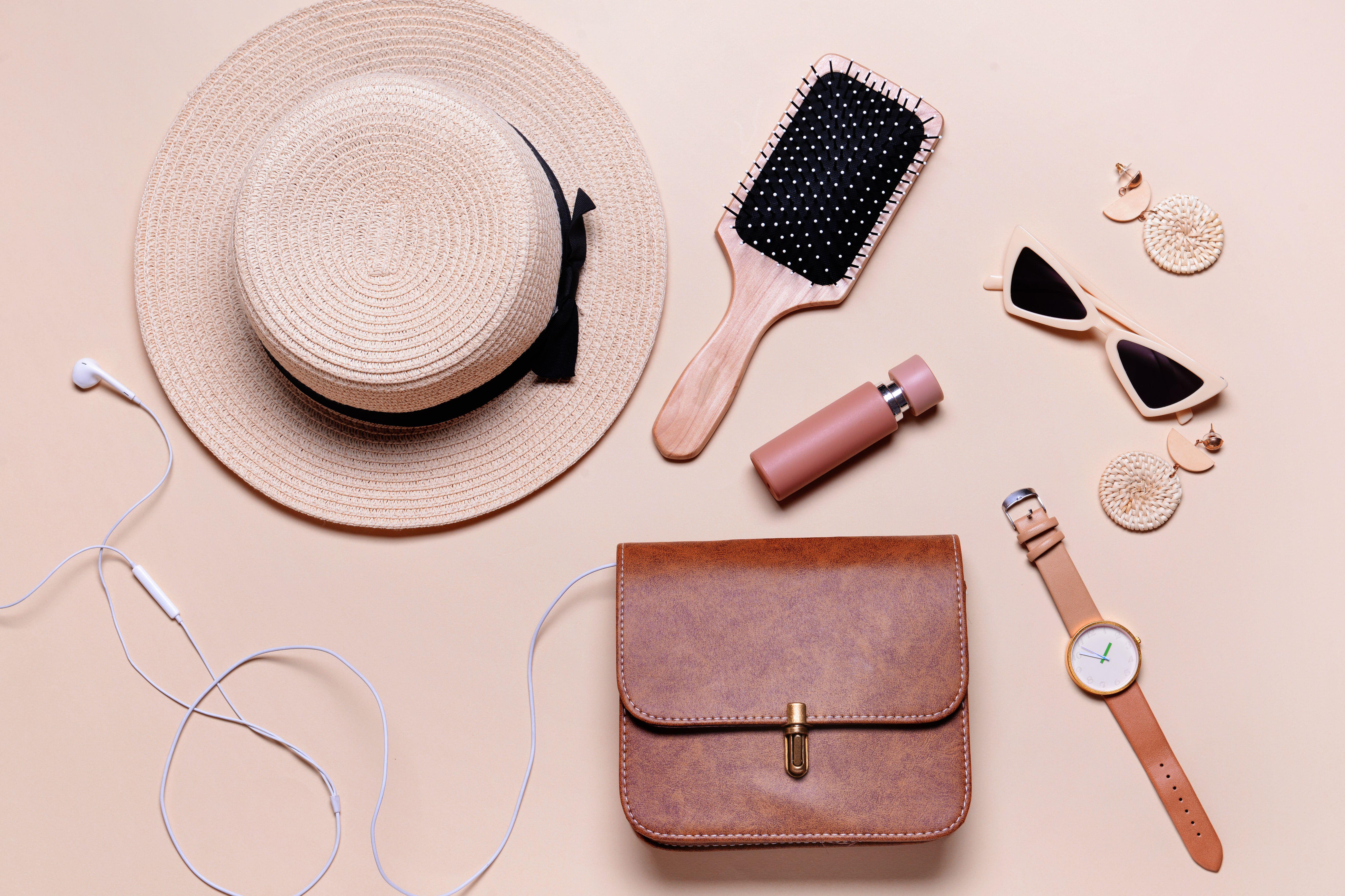 Hairbrush and other objects next to small handbag