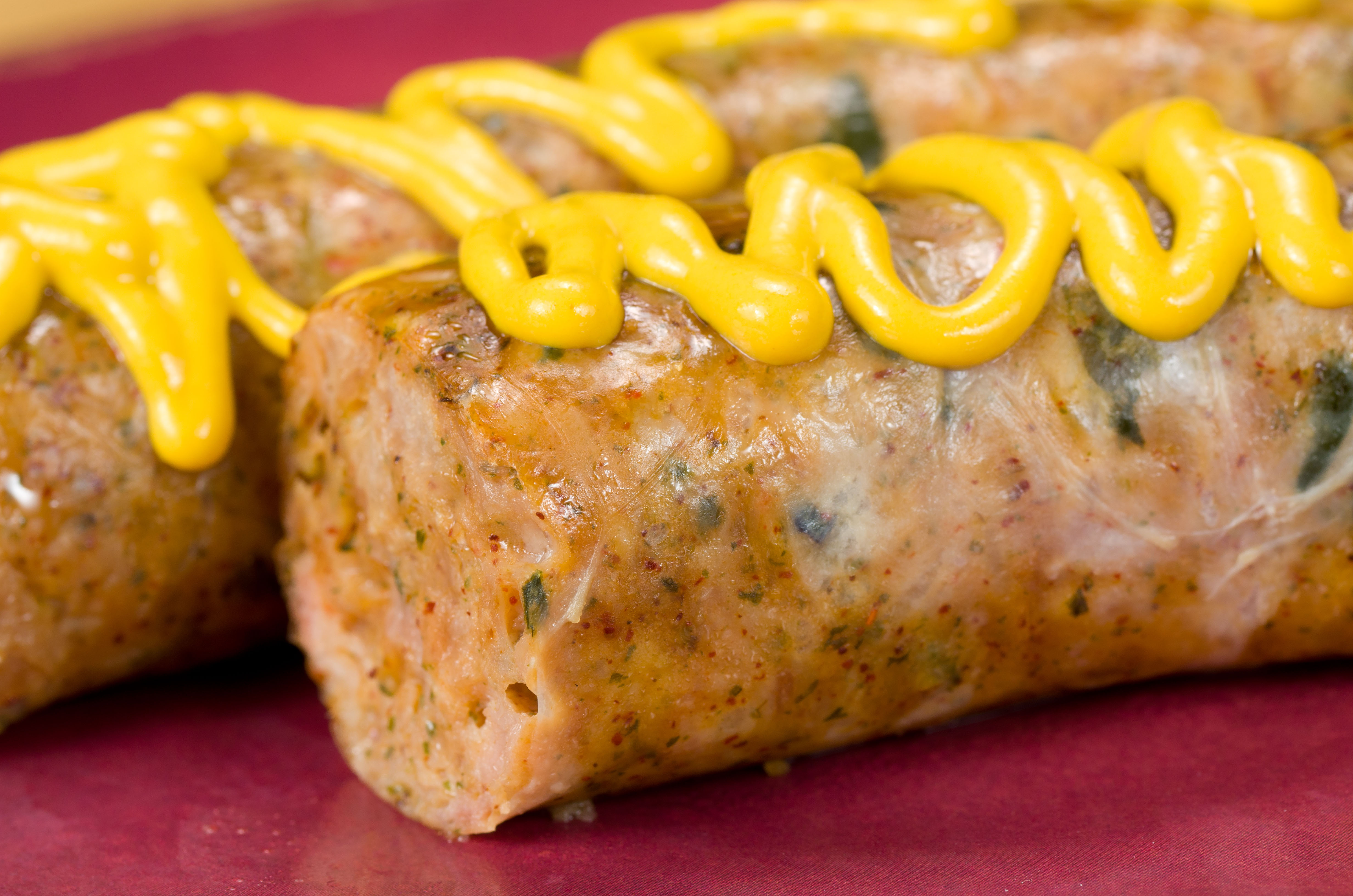 Mustard on top of two sausages