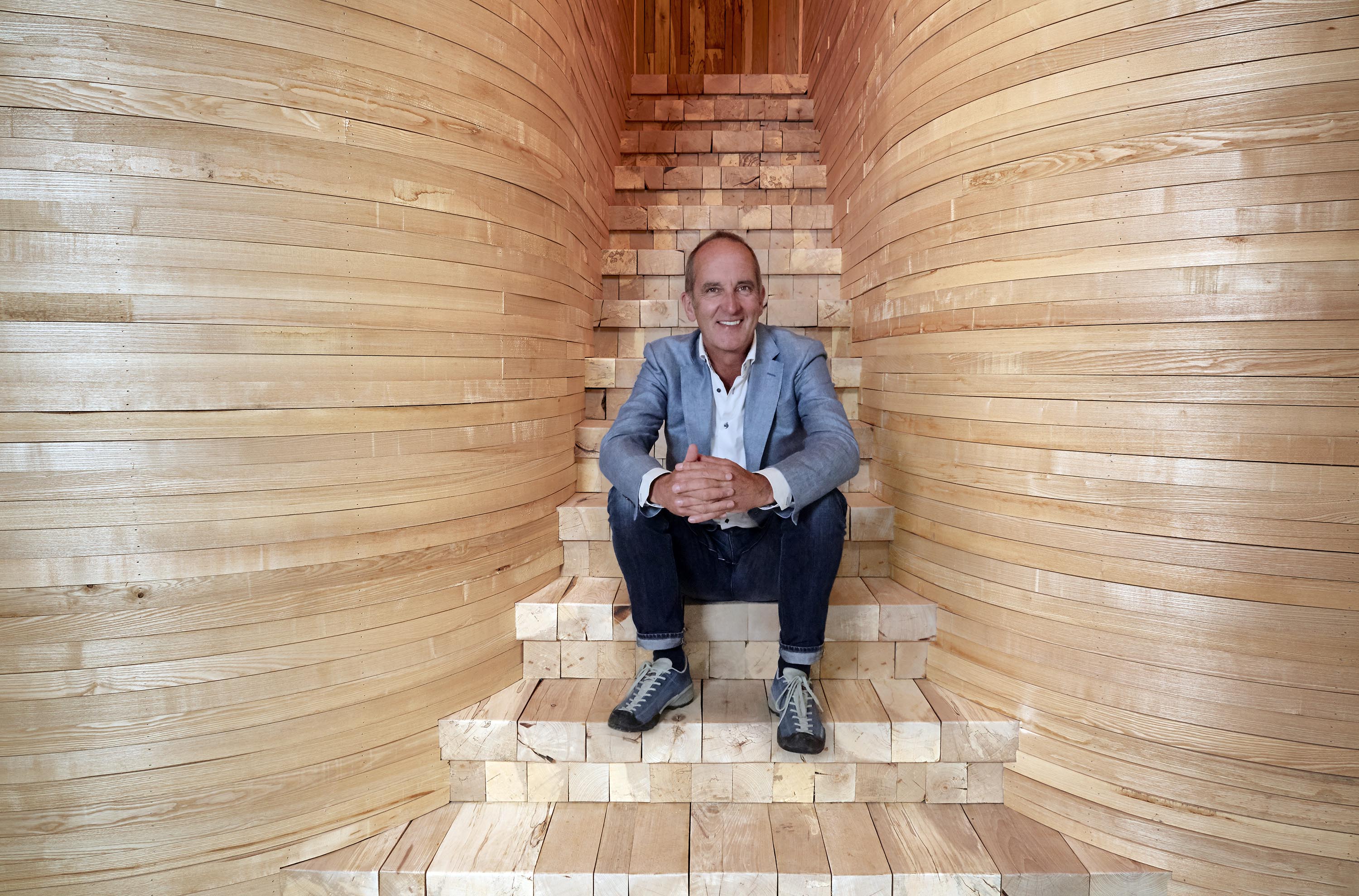 Kevin McCloud sitting on a flight of stairs (FreemantleUK/Channel 4/PA)