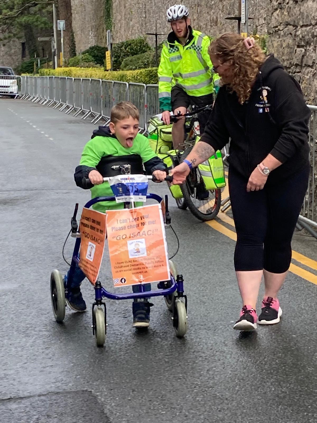 Boy with walker with woman