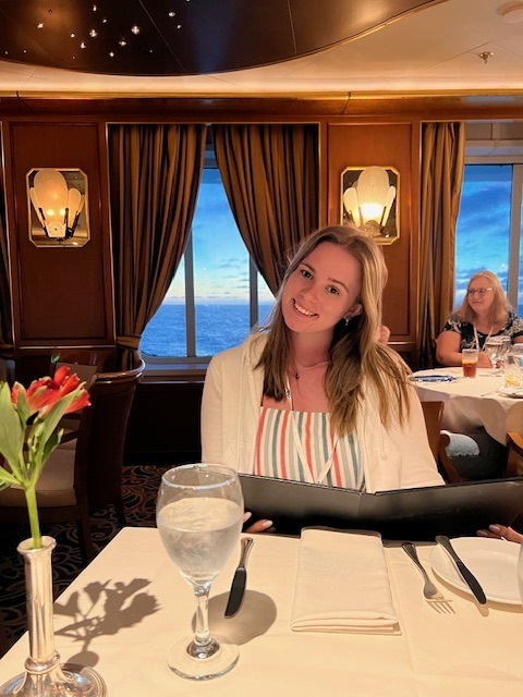 Jamilla Blake with the menu at a table in a restaurant