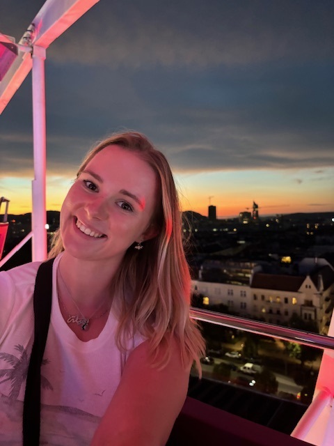 Jamilla Blake smiling with a sunset behind her