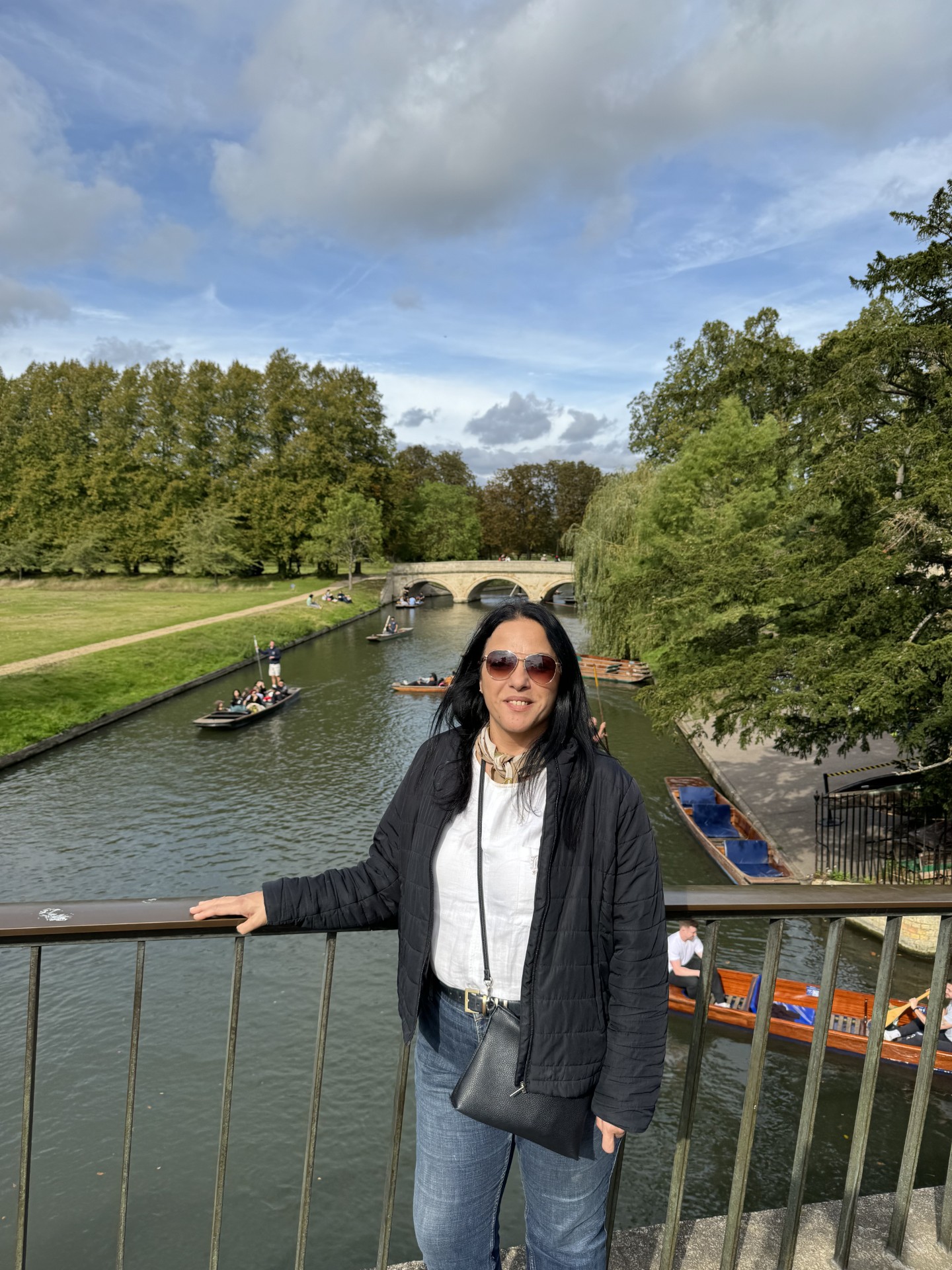 Woman standing on bridge looking at the camera 