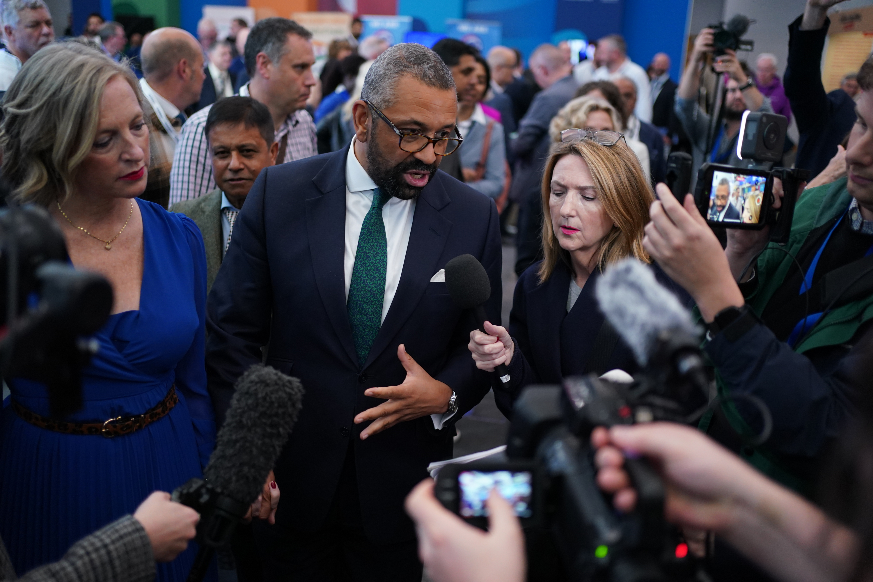 Tory leadership candidate, James Cleverly and his wife Susie surrounded by media at the Conservative Party Conference 