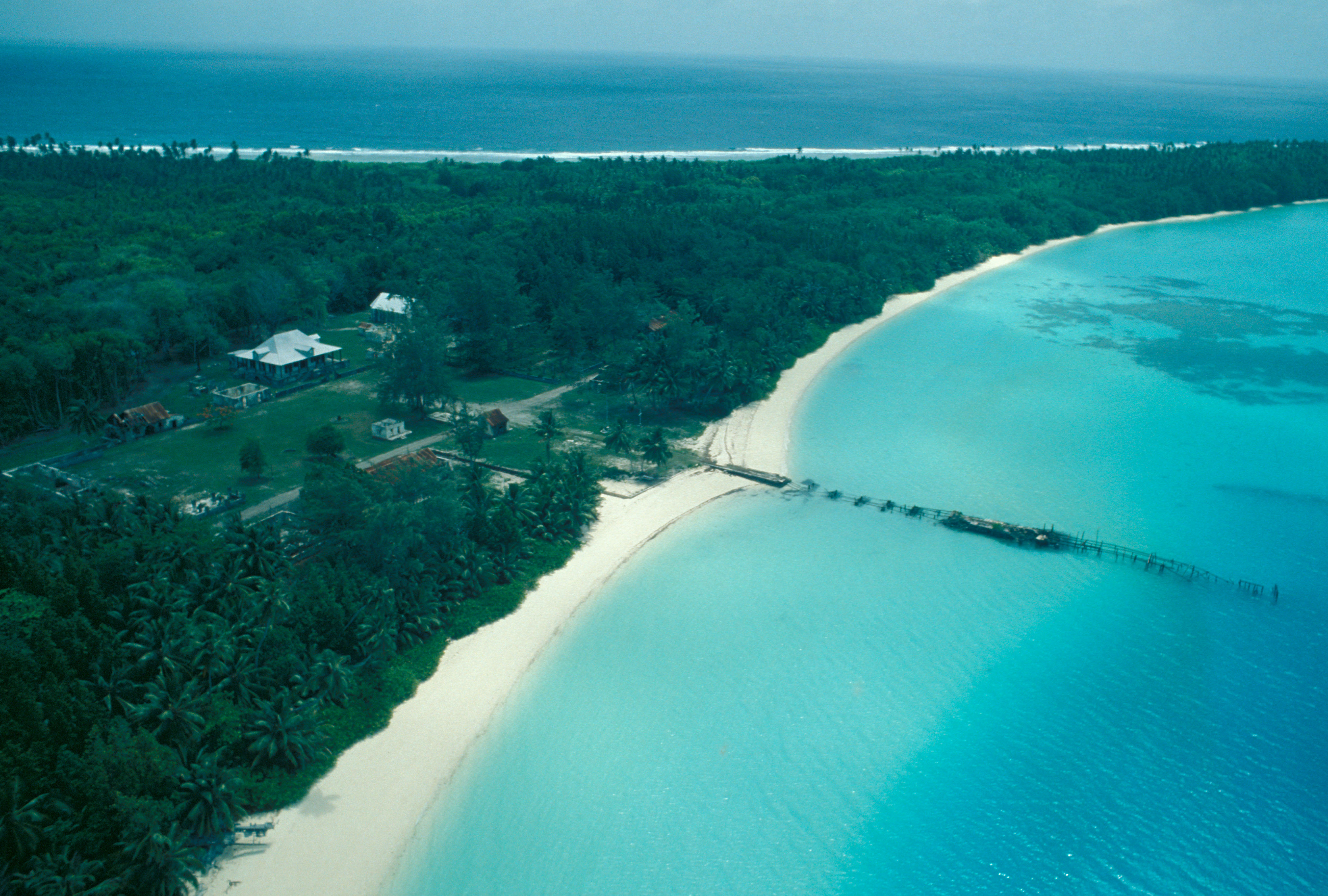 An aerial view of roads, buildings and forest on Diego Garcia