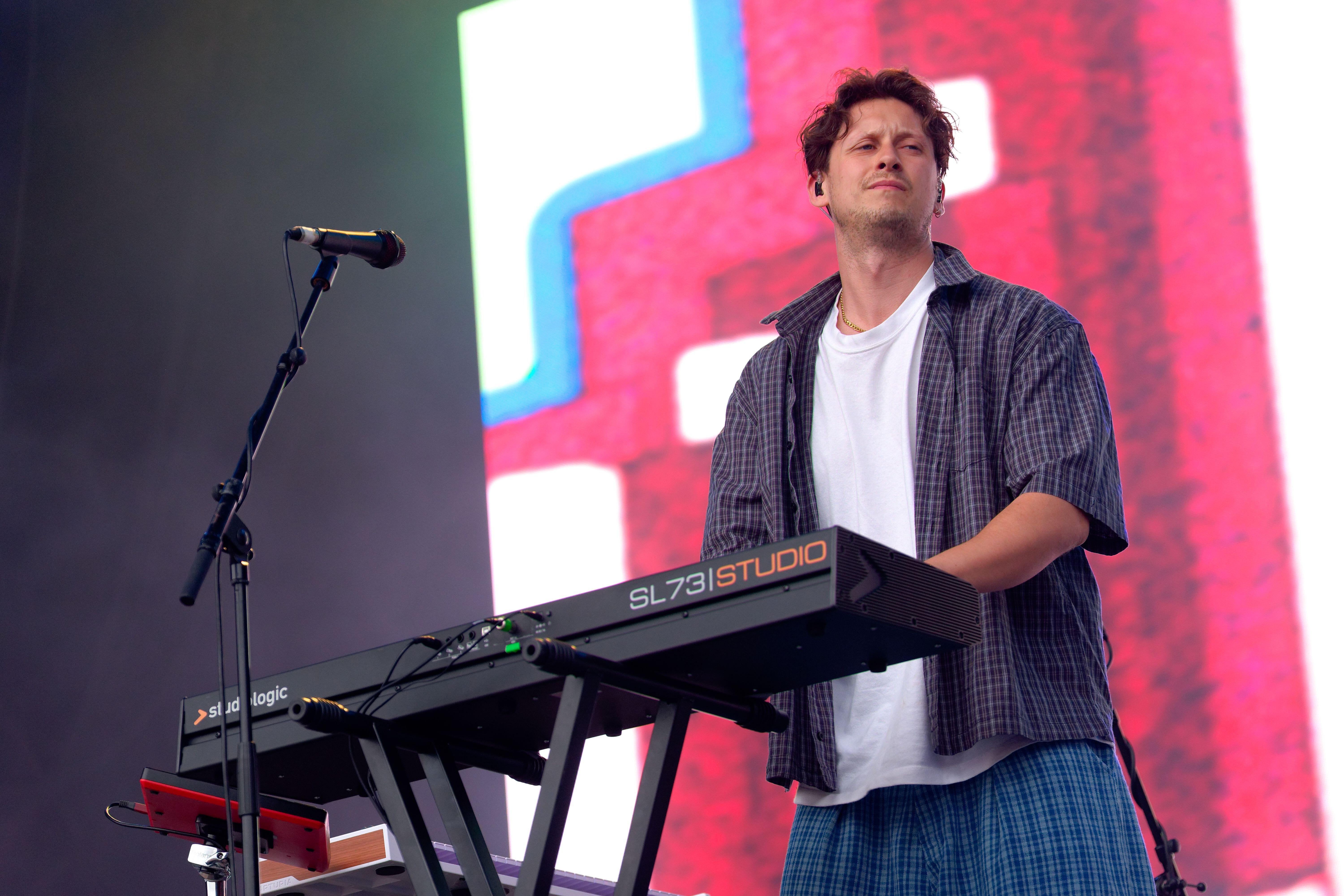 Barry Can't Swim playing a keyboard while performing on stage