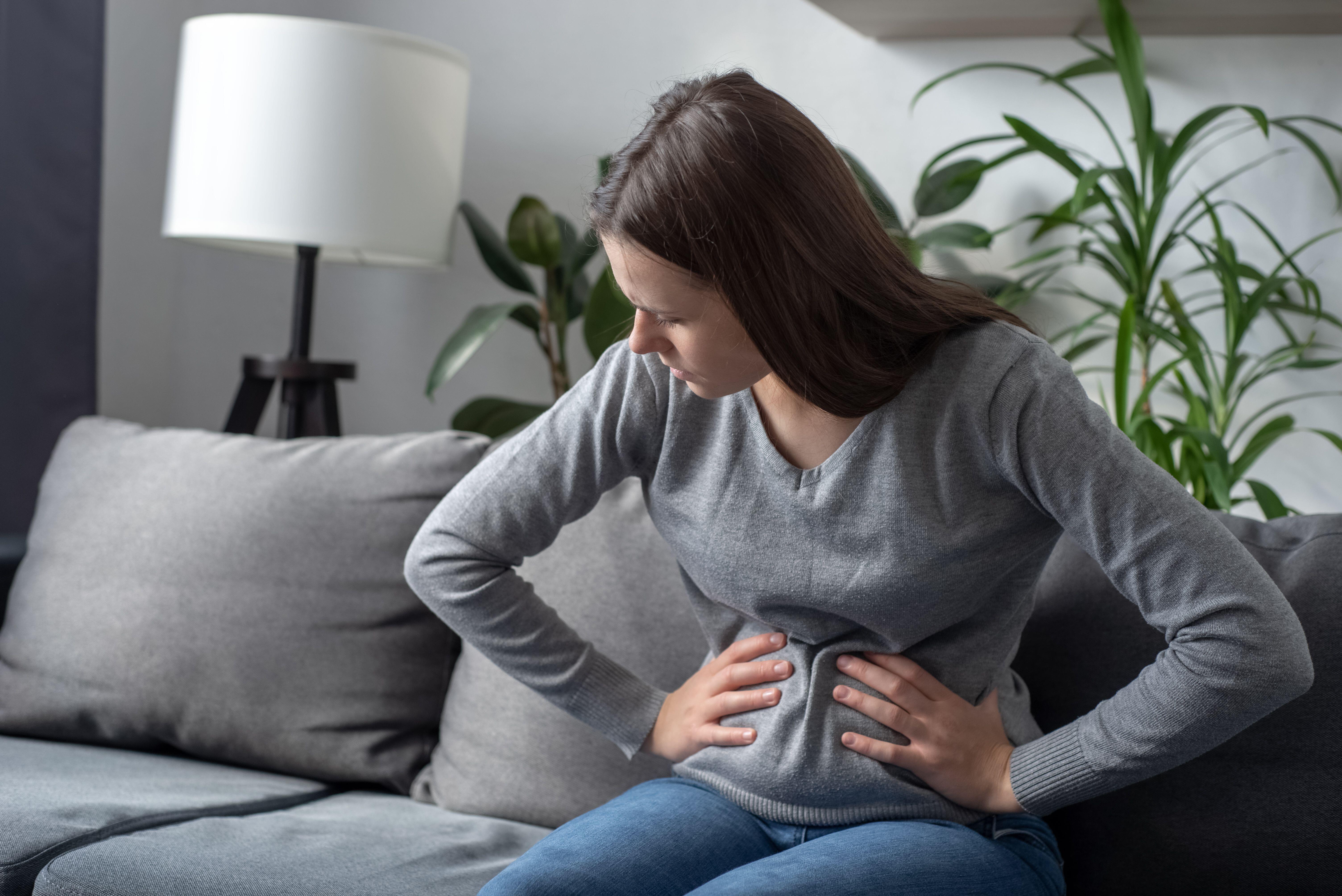 Young woman experiencing stomach cramps