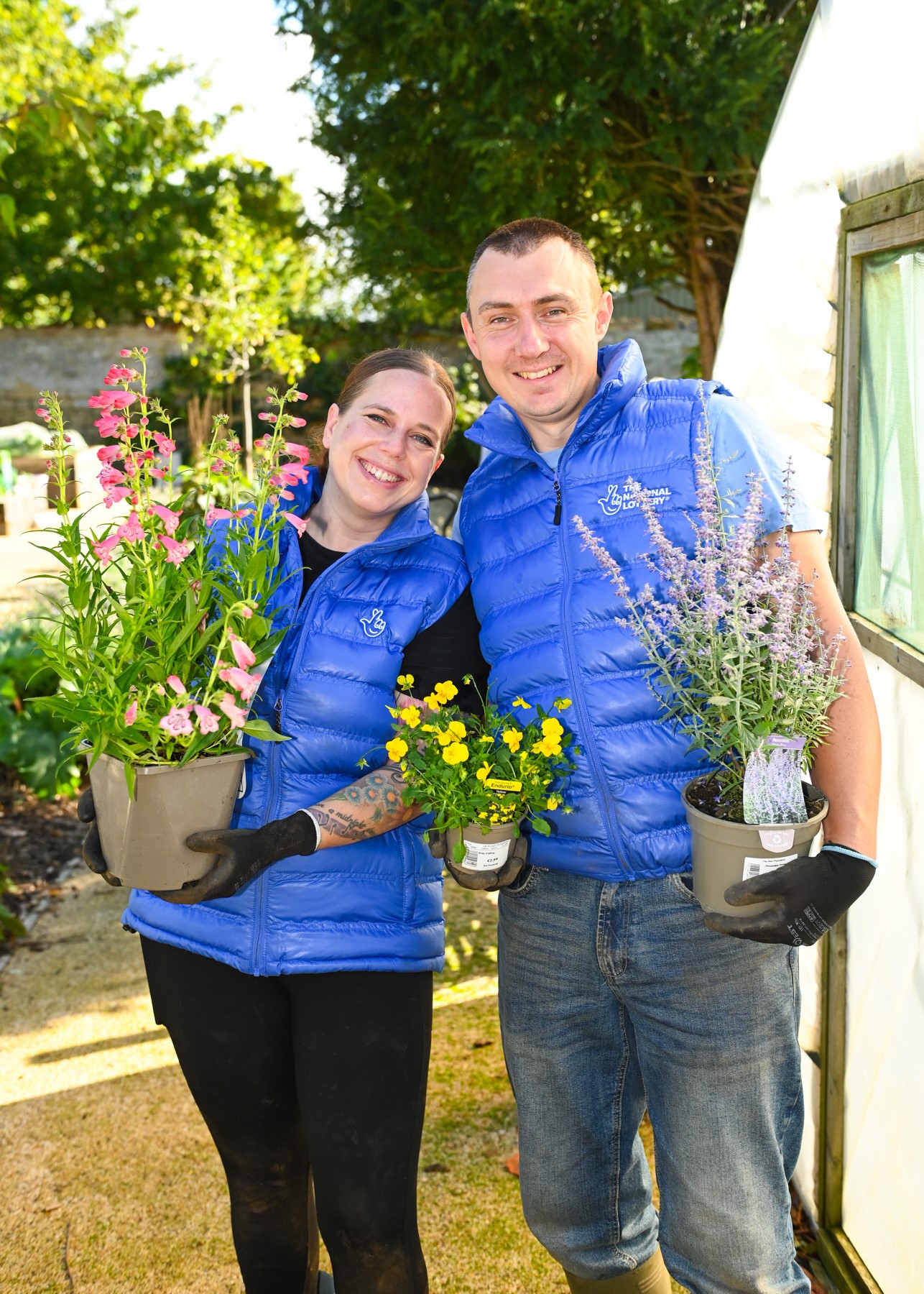 Lottery winners Katherine and Graeme White help spruce up a garden for toddlers at Sacrewell Farm in Peterborough. (National Lottery/ PA)