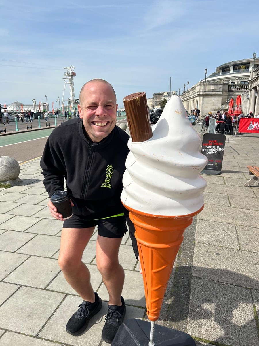 Darren Wood pictured next to a huge promotional plastic ice cream at Brighton seafront