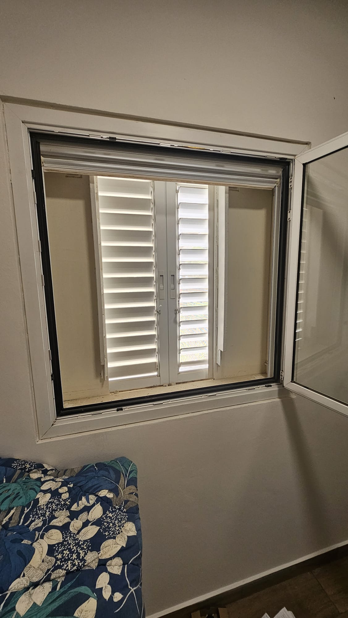 A window with shutters and an extra door for protection