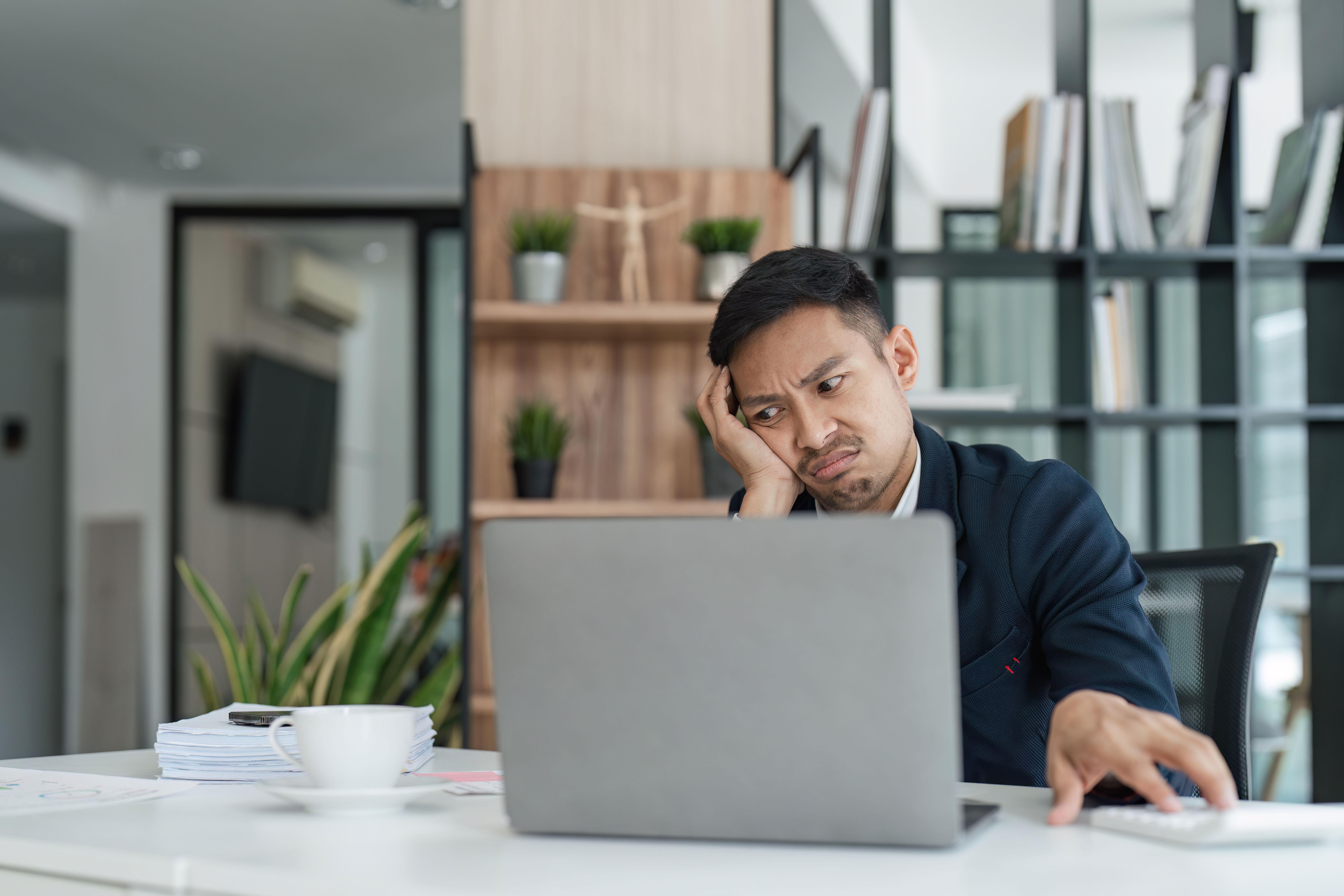 Burnt out man struggling to focus in an in office 